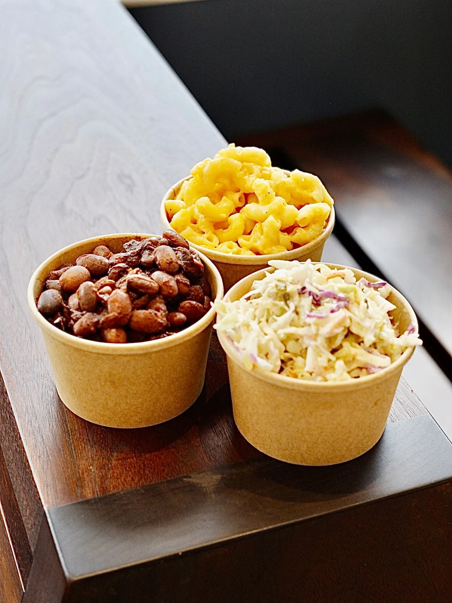 Don&rsquo;t forget to snag one or all three of our delicious sides with your dogs! Our Velveeta Mac &amp; Cheese, smoky baked Beans and classic Coleslaw. Open at noon until 6pm. See you soon!