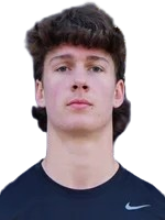 A young man with curly dark hair wearing a dark sports shirt, looking directly at the camera.