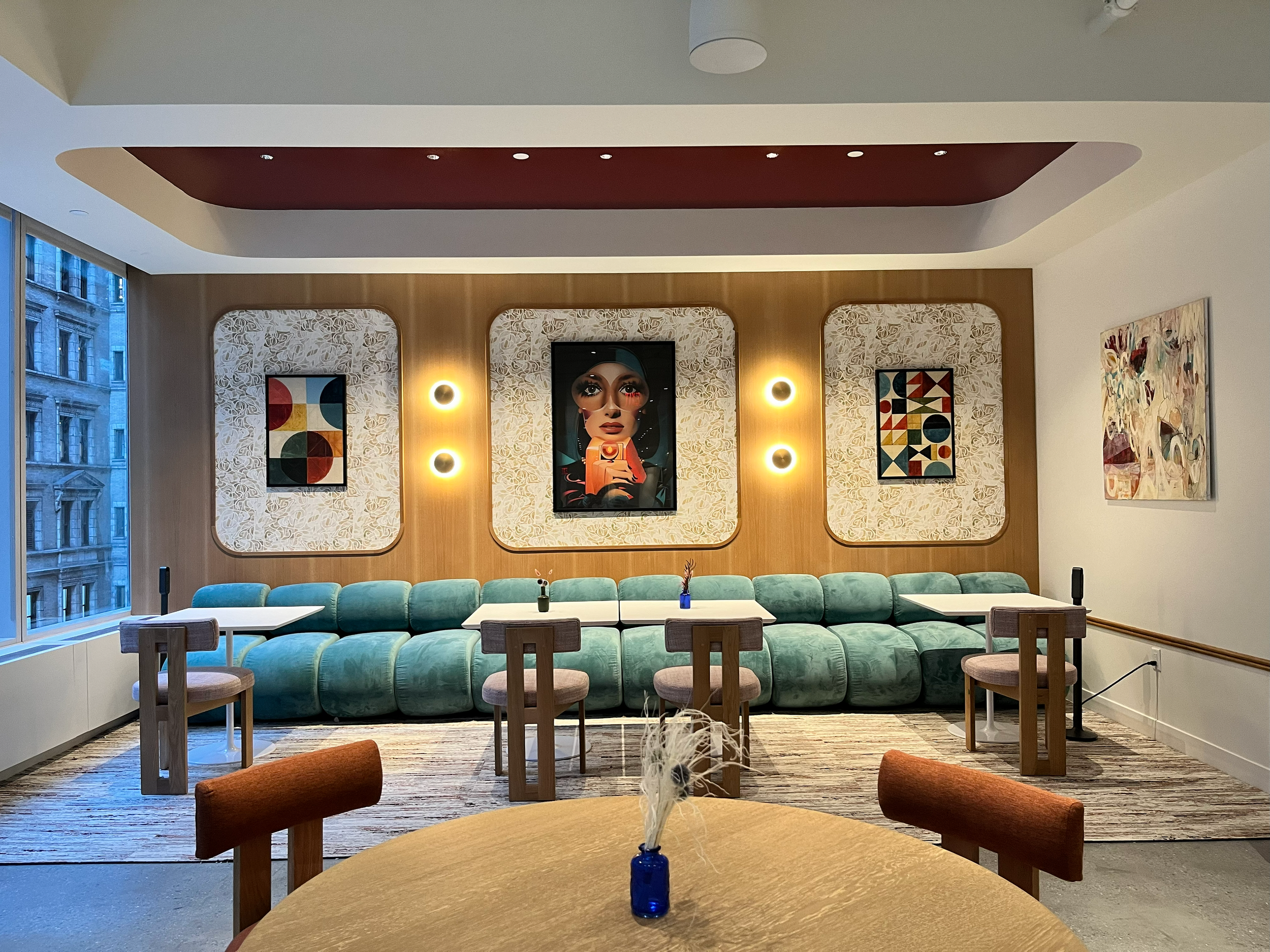 Lounge seating in teal velvet with framed portrait art and wall sconces, part of Marlo and Kroft's portfolio