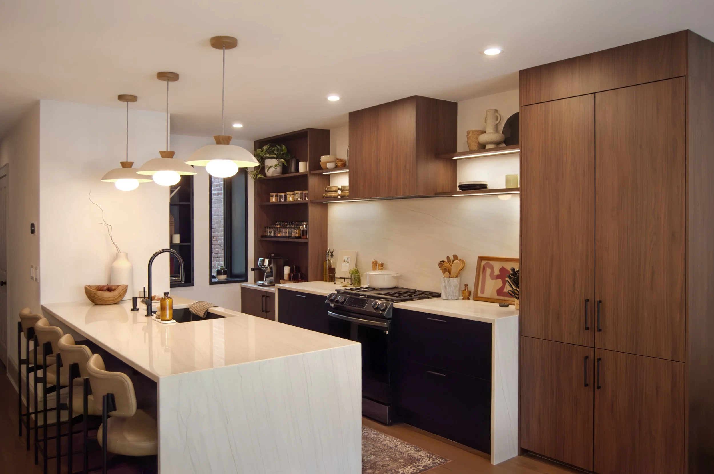 Matte black and walnut kitchen with black hardware, white quartzite island, in a Lancaster, PA historic townhome renovation