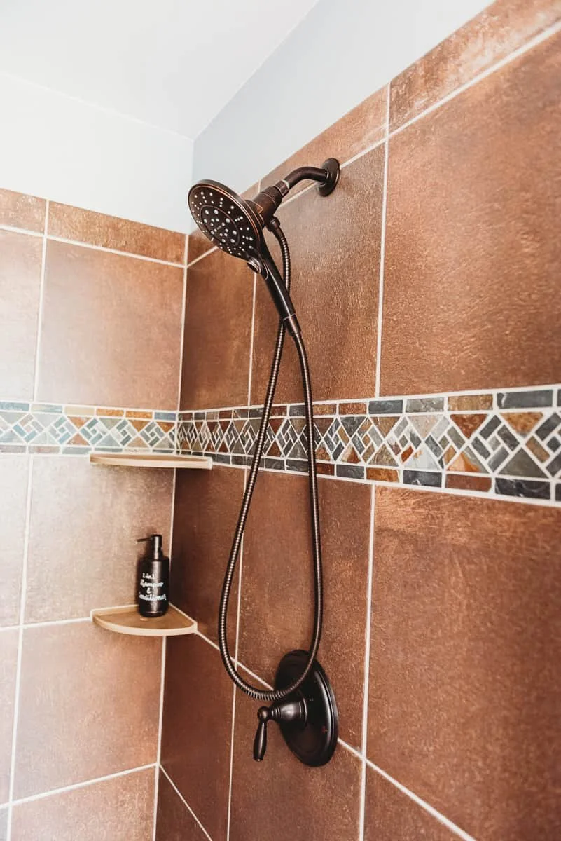 Tiled shower with removable handheld head.