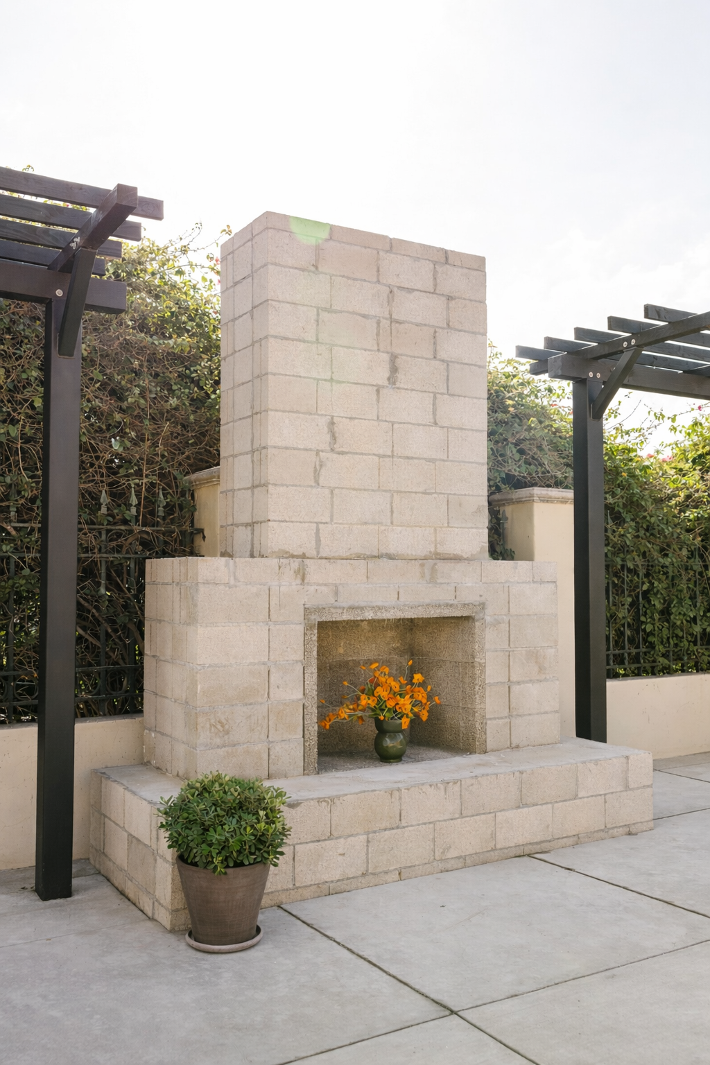 The outdoor fireplace anchors the patio as a natural gathering point. Built from simple, timeless materials, it brings warmth and structure to the space—equally suited for casual conversations or evening celebrations.
