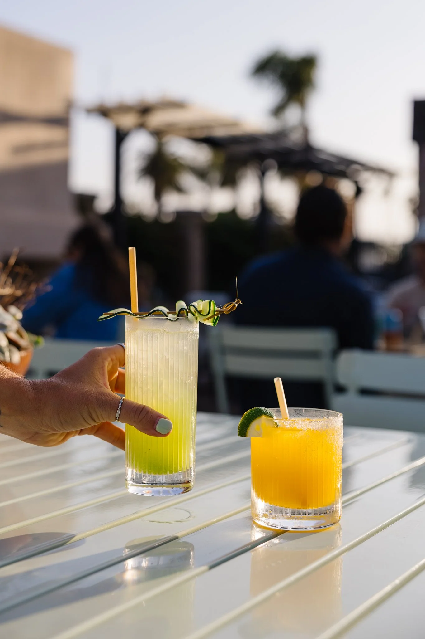 Guests toasting handcrafted cocktails during patio nights at Palomino in downtown Ventura.