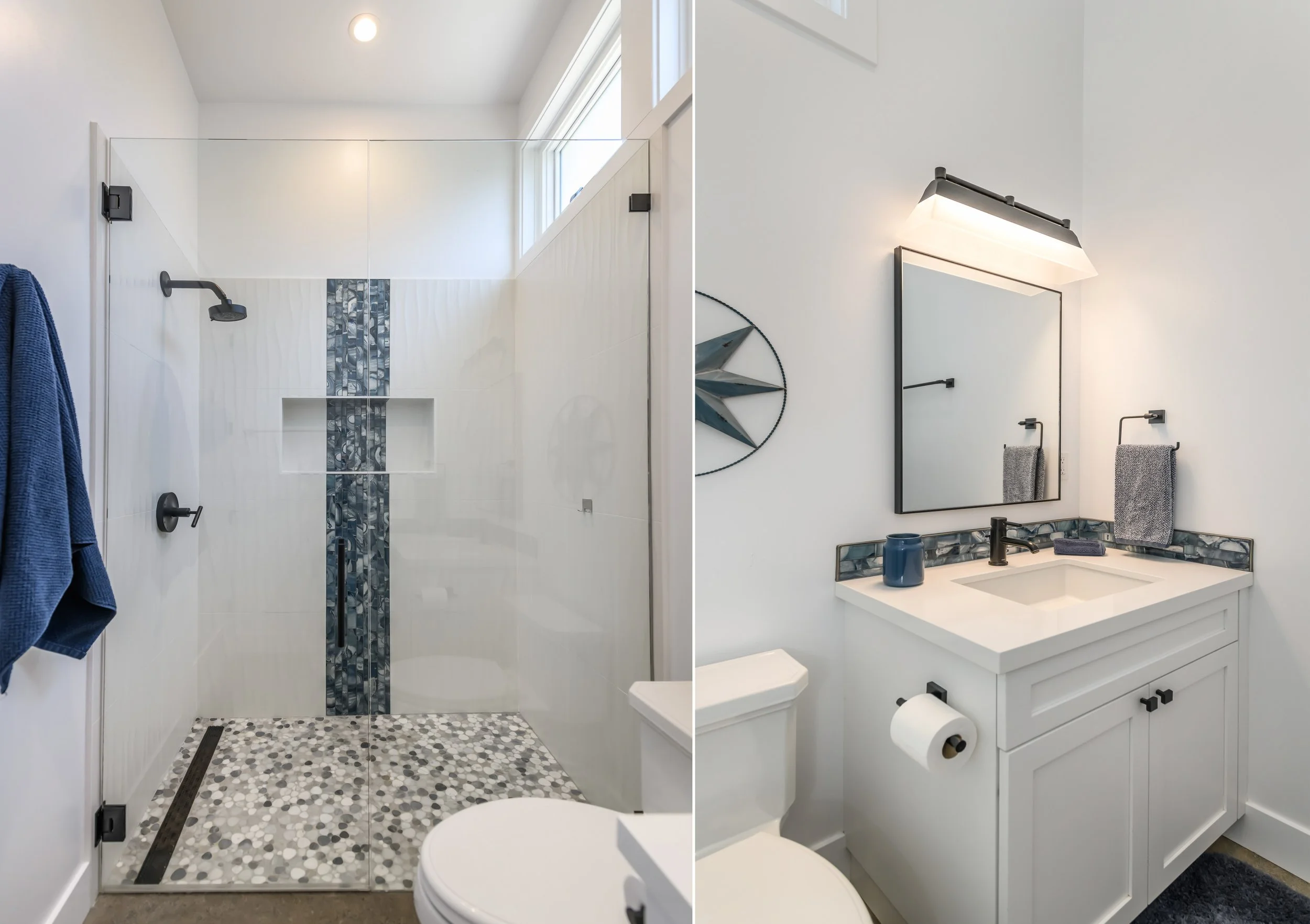Split view of a bathroom, showing a glass shower enclosure with pebble tile floor and wall decor on the left, and a white vanity with a mirror and towel racks on the right.
