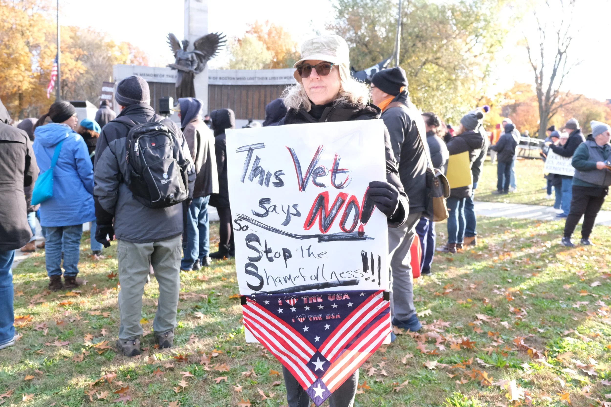 Veteran holds a protest sign (BU Daily Free Press, Nov. 2025)