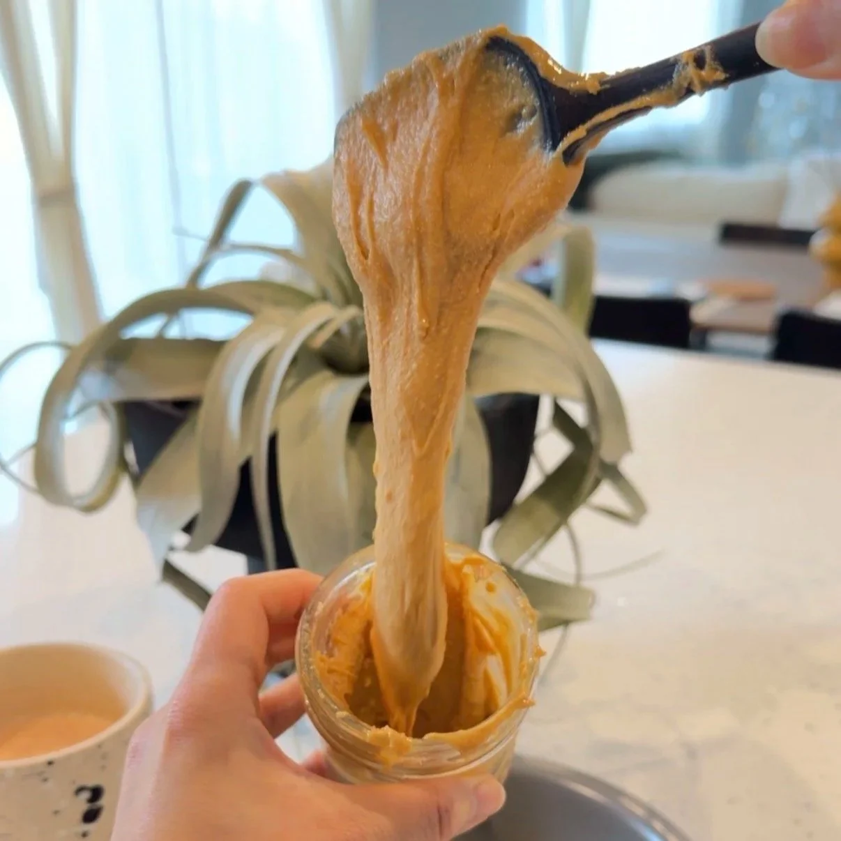 Creamy peanut butter flowing down into a mason jar. Simple, easy, and one ingredient only peanut butter. No additives, preservatives, salt or oil added. Last for 6 months.