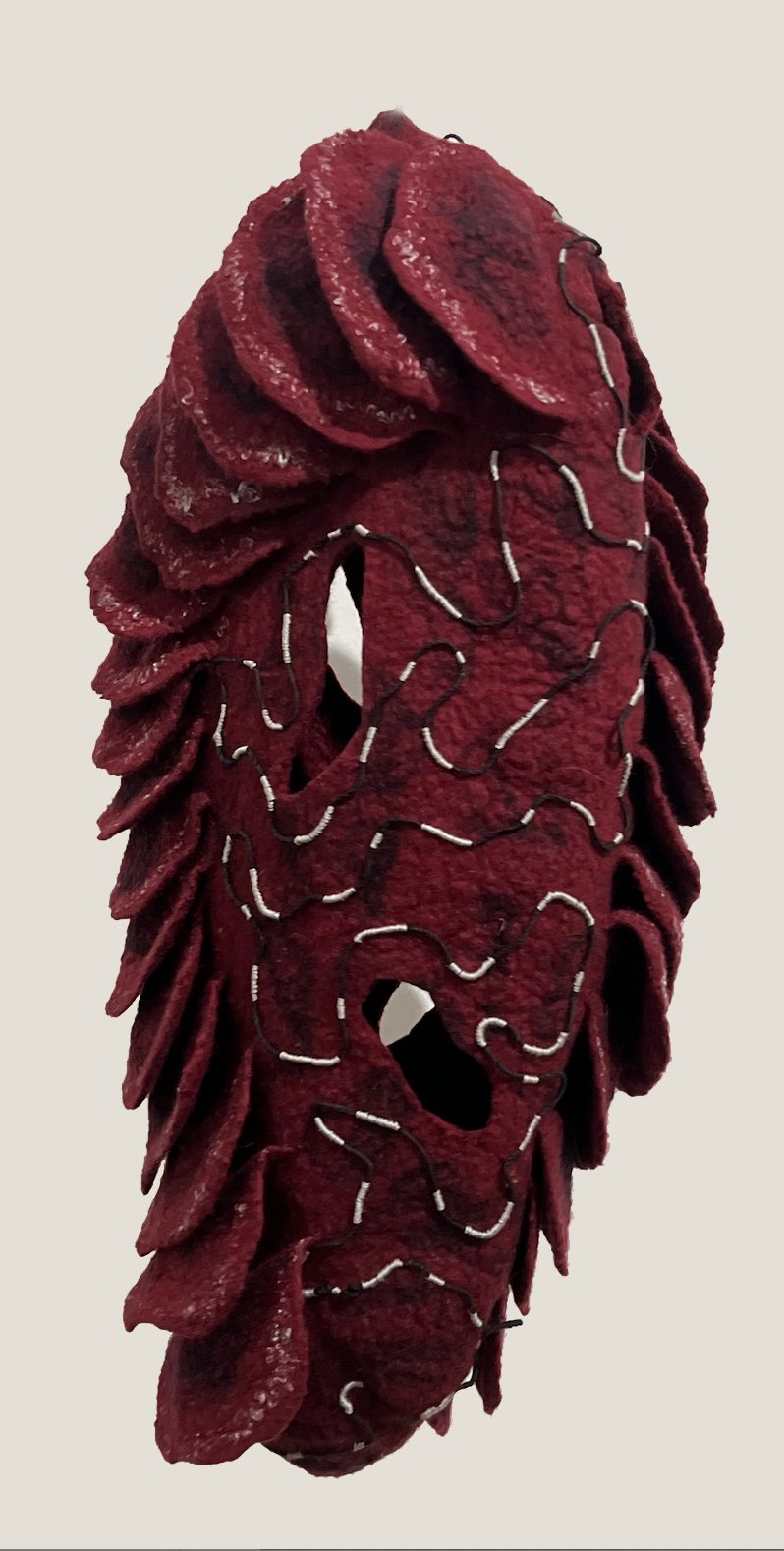 "Seed Pod 2" 2024, wool roving, beads, thread (19 x 9 x 6”)