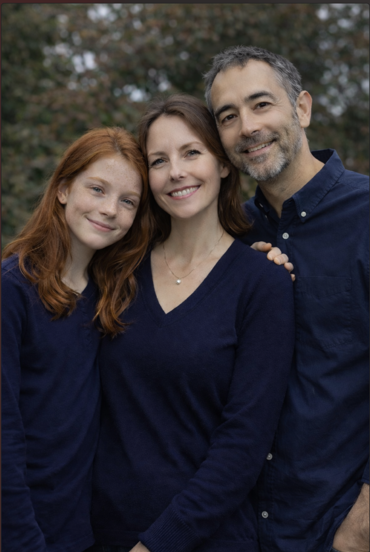 Family of three standing outdoors representing virtual family counselling in Ontario.