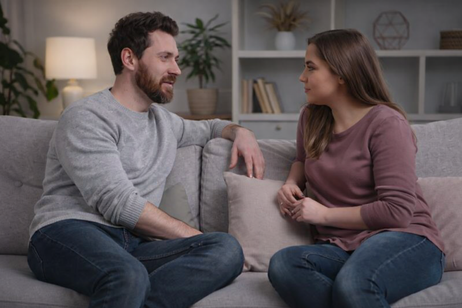 Man and woman sitting on a couch in conversation, representing infidelity and marriage counselling at Watkins Counselling & Wellness in Smiths Falls.