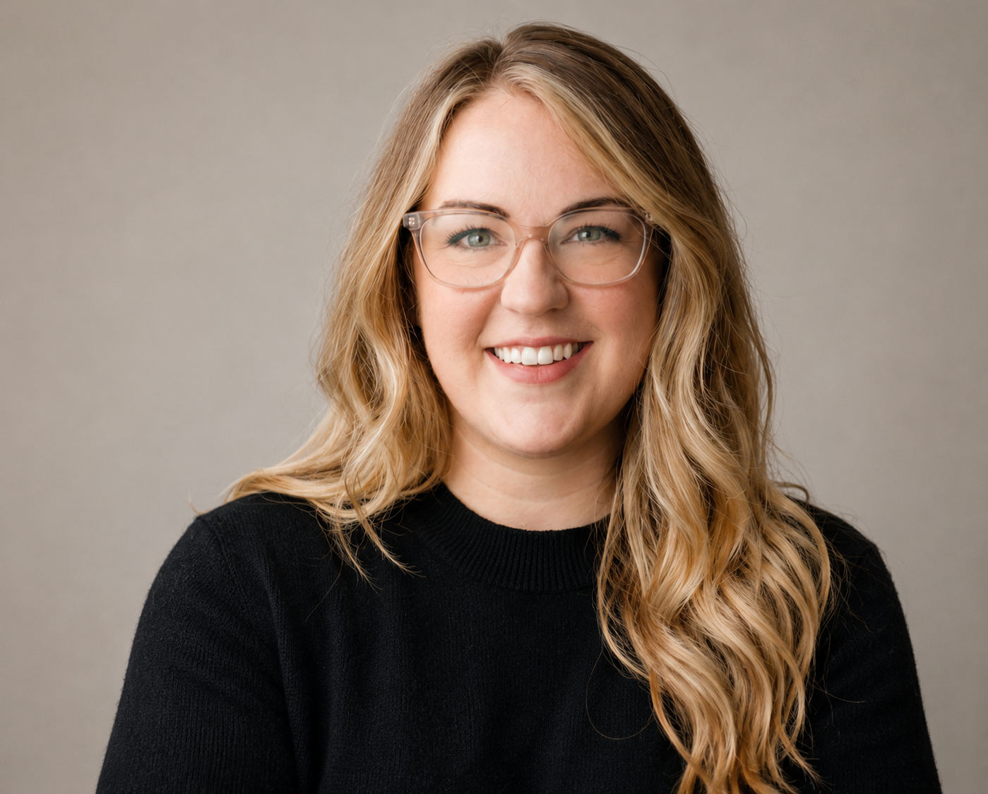 Professional black Portrait of Kassandra Smalley, Registered Psychotherapist (Qualifying) at Watkins Counselling & Wellness, with soft studio lighting and a neutral background.