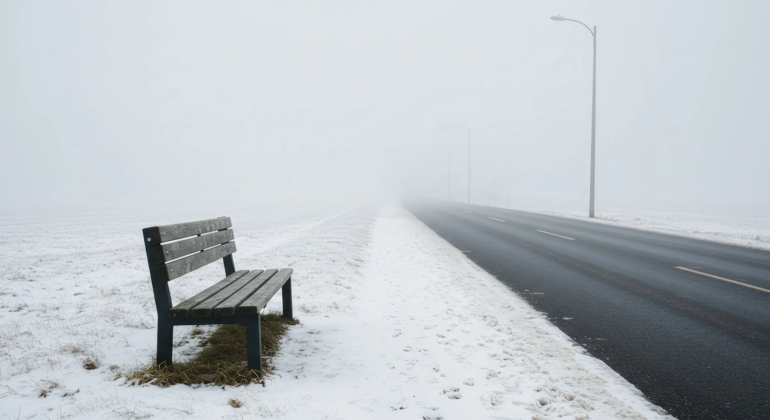 a solitary bench beside a foggy winter road symbolizing burnout and emotional exhaustion, representing therapy support in smiths falls, ontario.