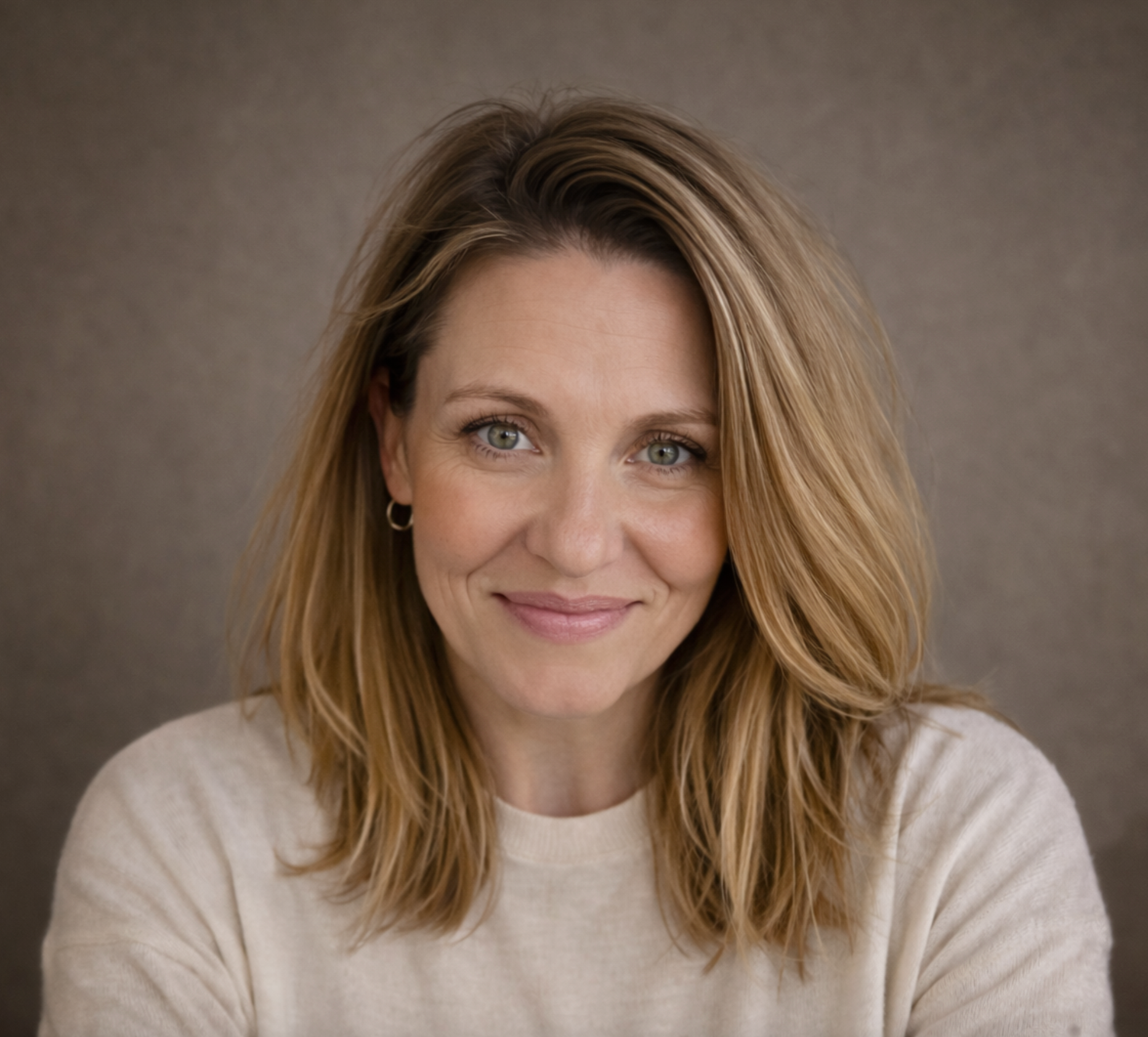 Joe-Ann Watkins, Registered Psychotherapist and founder of Watkins Counselling and Wellness, smiling against a soft taupe background