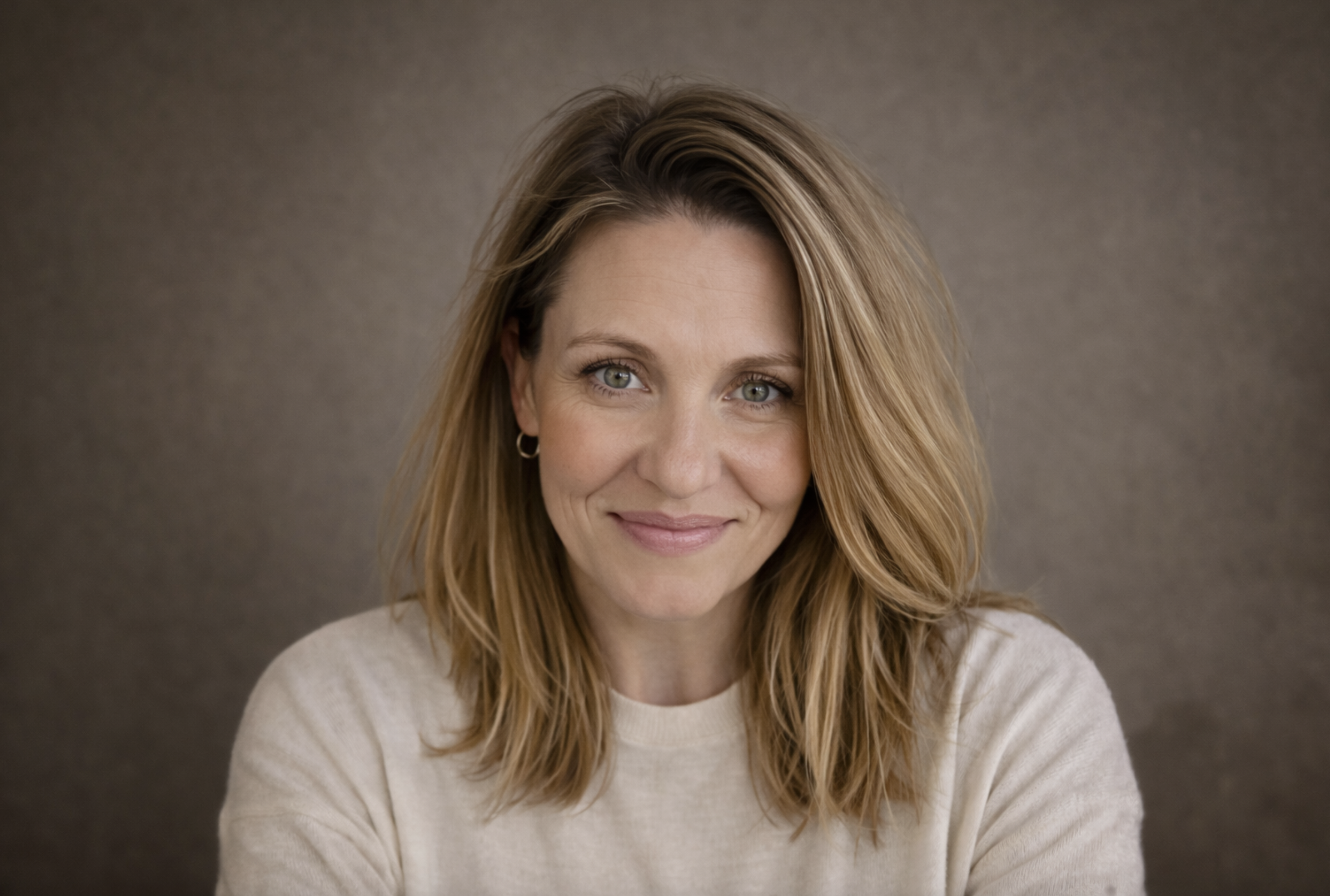 Joe-Ann Watkins, Registered Psychotherapist and founder of Watkins Counselling and Wellness, smiling against a soft taupe background