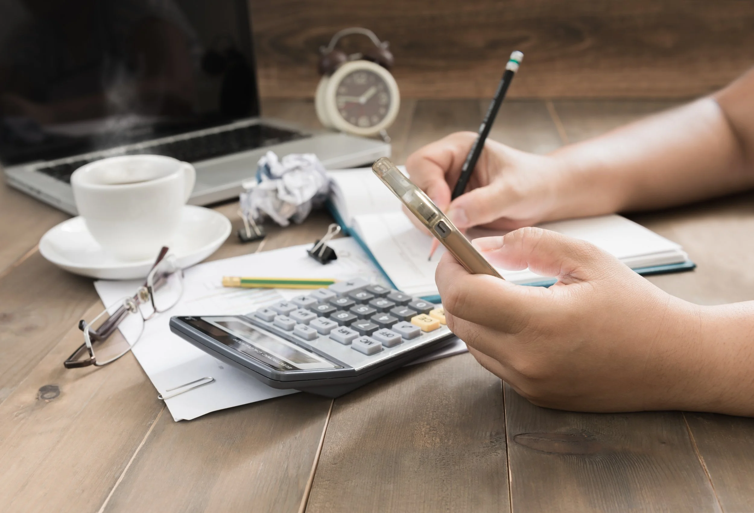 adult managing bills and work responsibilities while feeling overwhelmed, representing burnout therapy support in smiths falls, ontario.