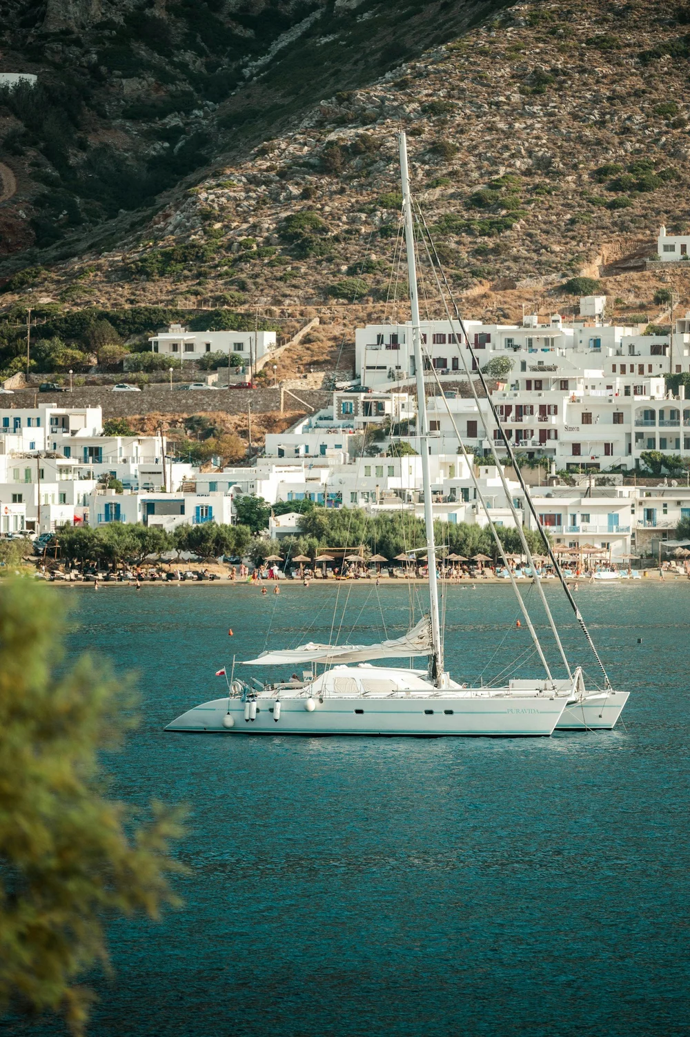 Sailboat beside a coastal town