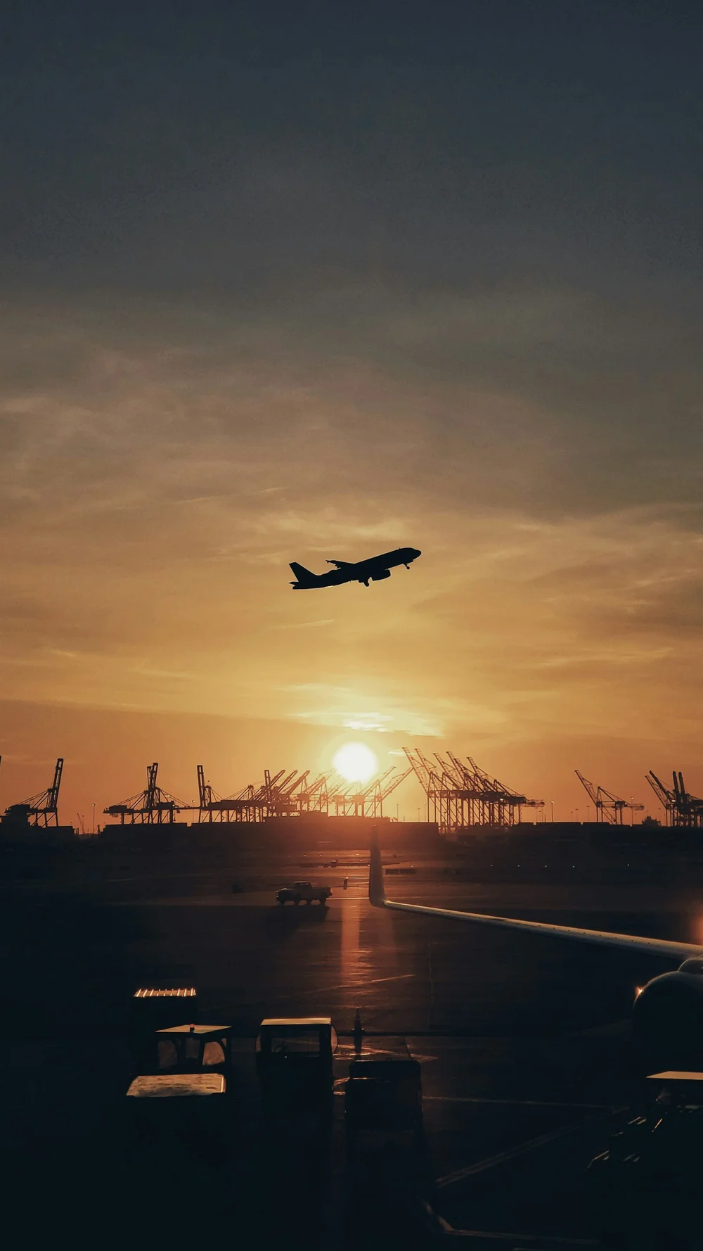 Airplane silhouetted against the sunset