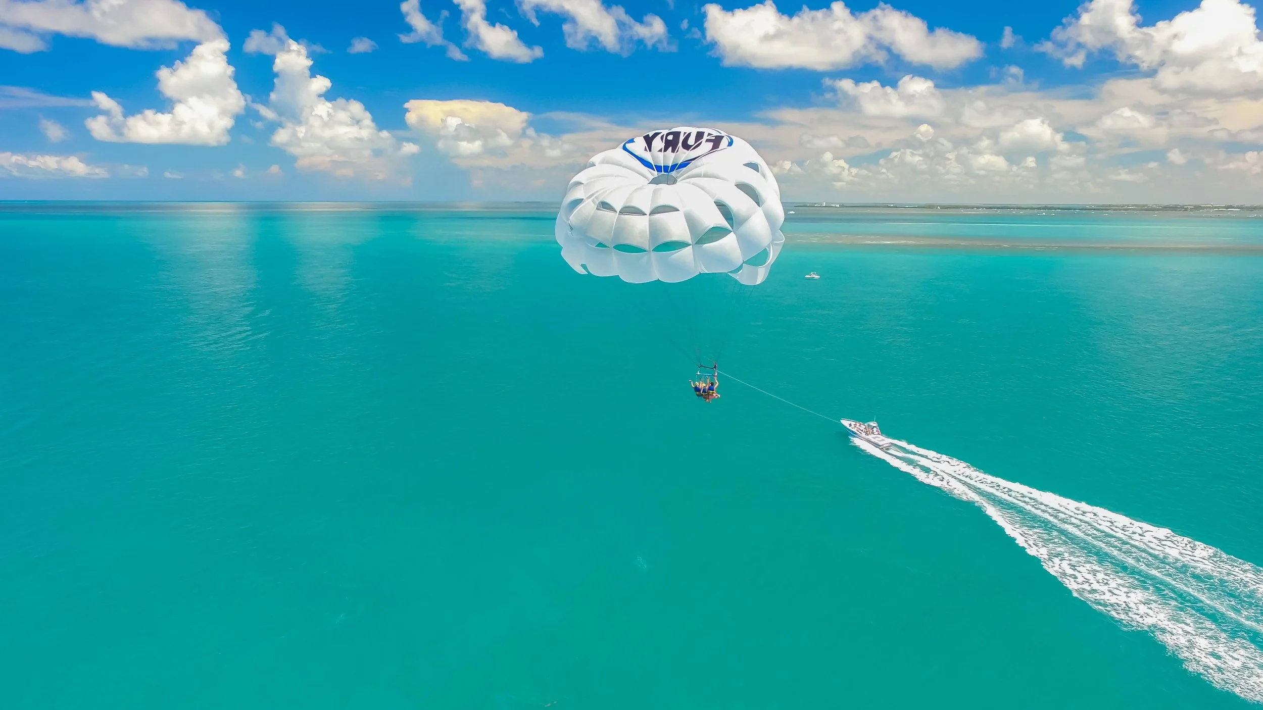 Fury parasailing above turquoise Key West waters
