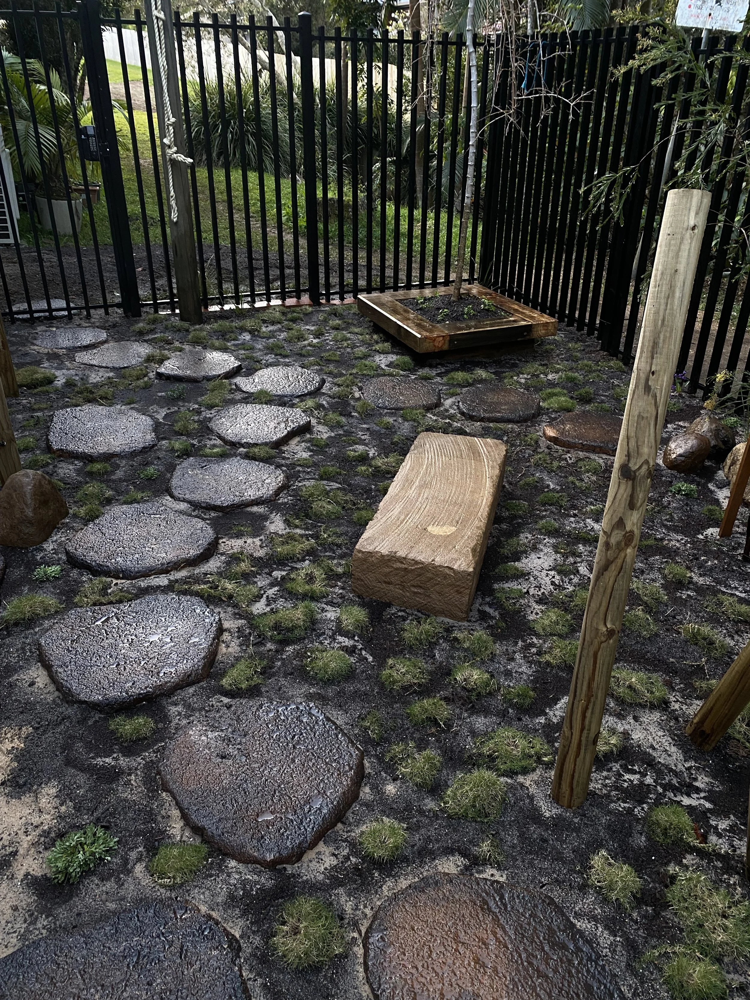 Child-friendly garden in Bangalow with lush lawn, shaded play spaces, and layered native planting.