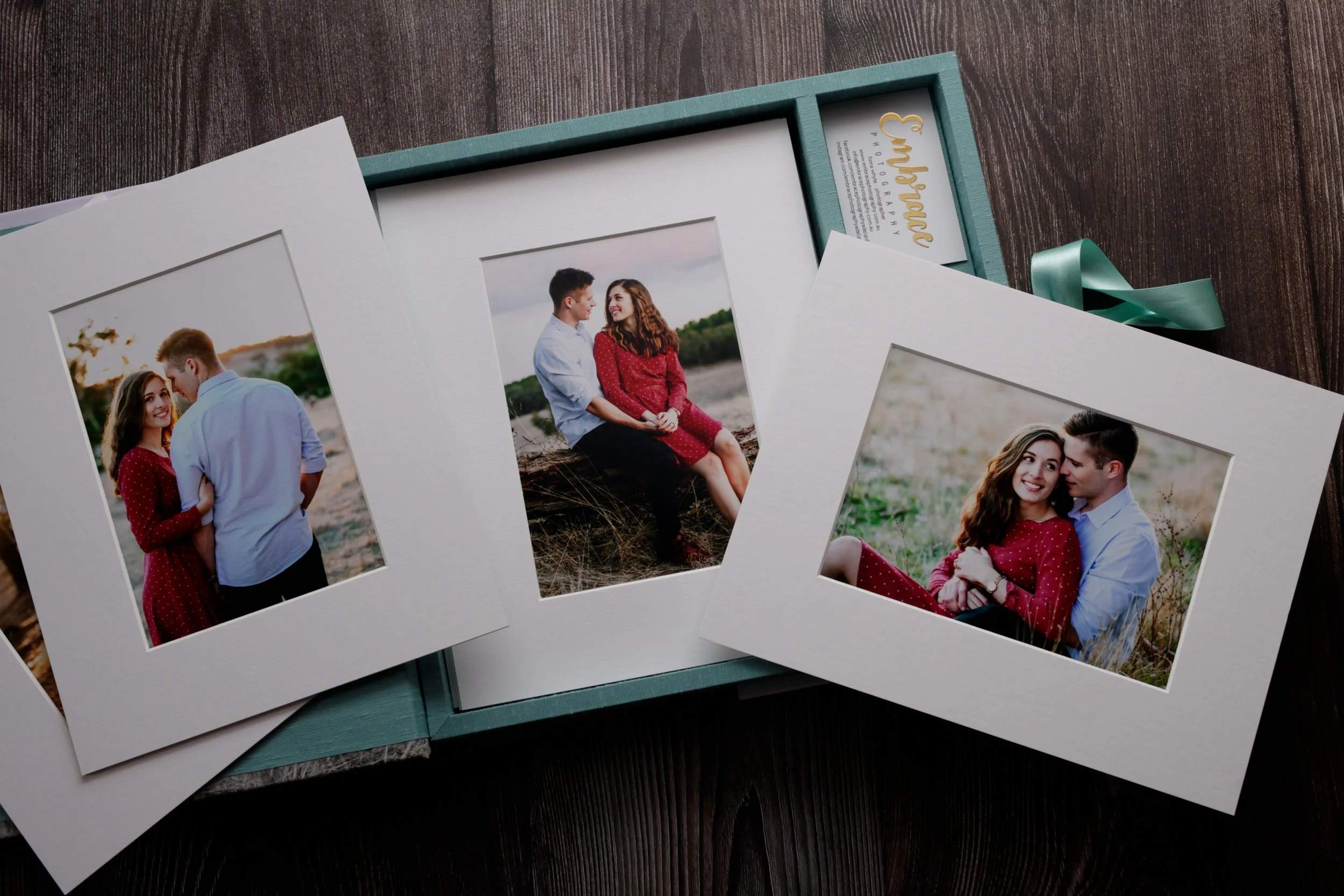Three framed photographs of a young couple in outdoor settings, with an open box in the background.