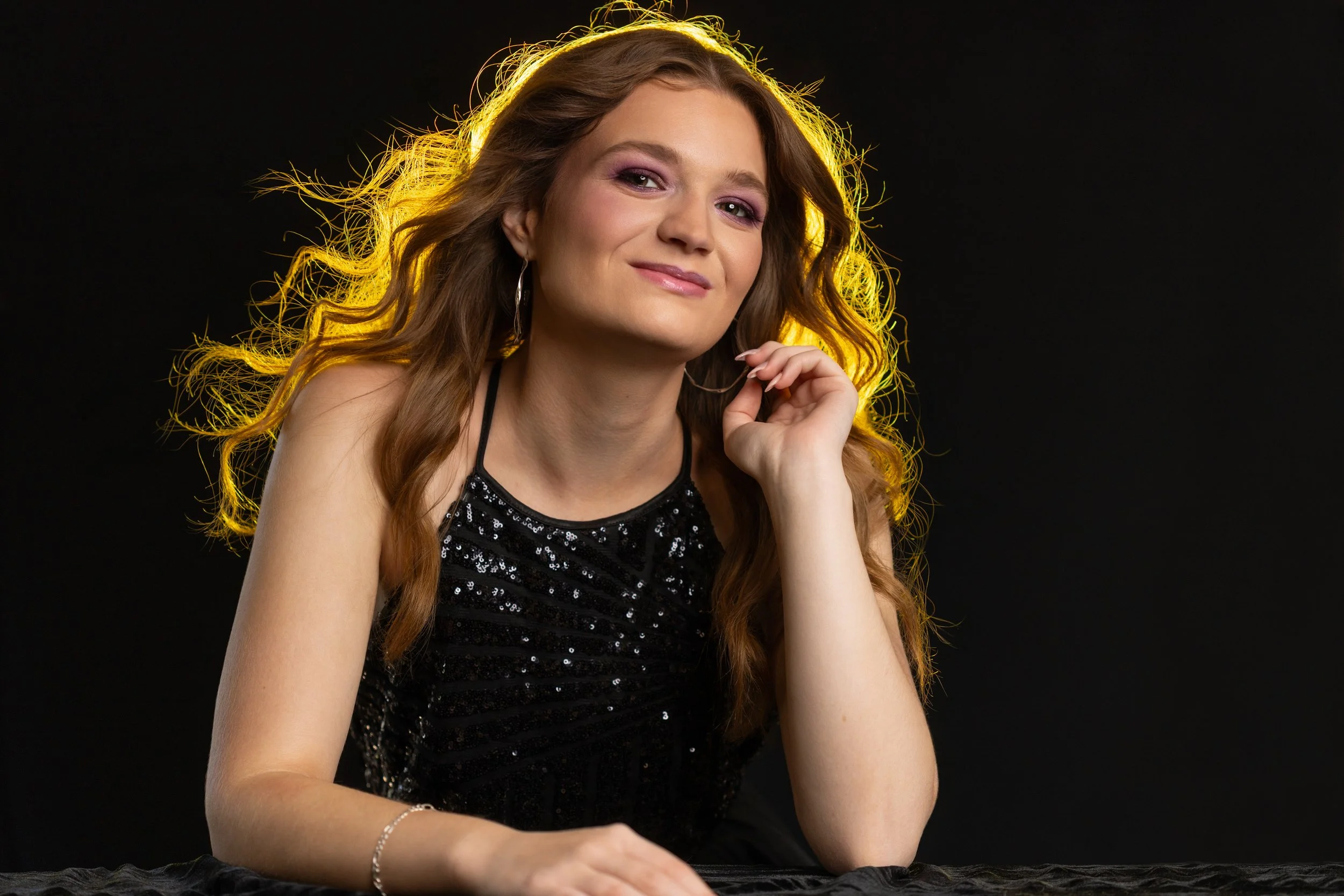 Studio Image of Girl with Black Background and Yellow Light