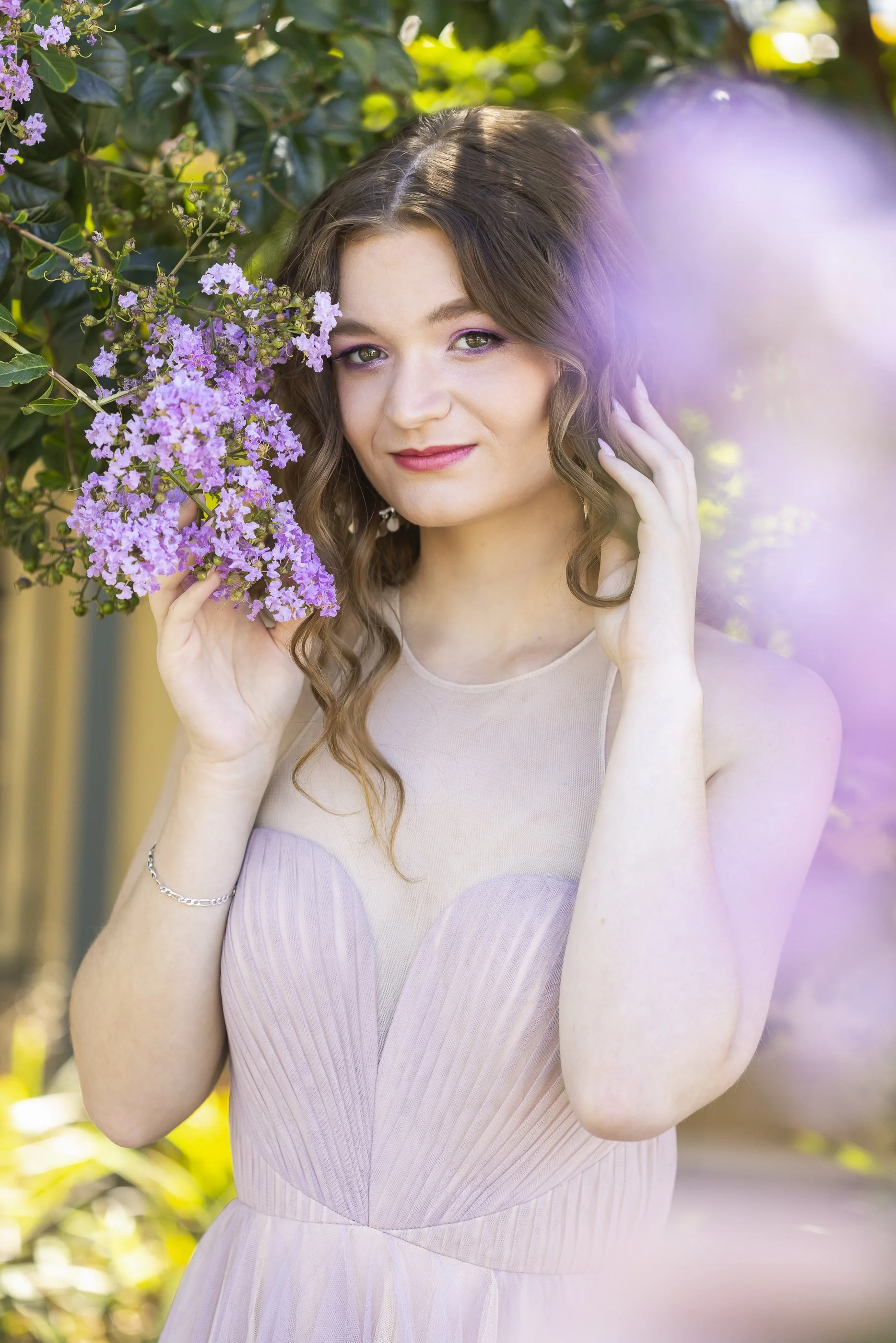 Image of Girl in nature with purple flowers