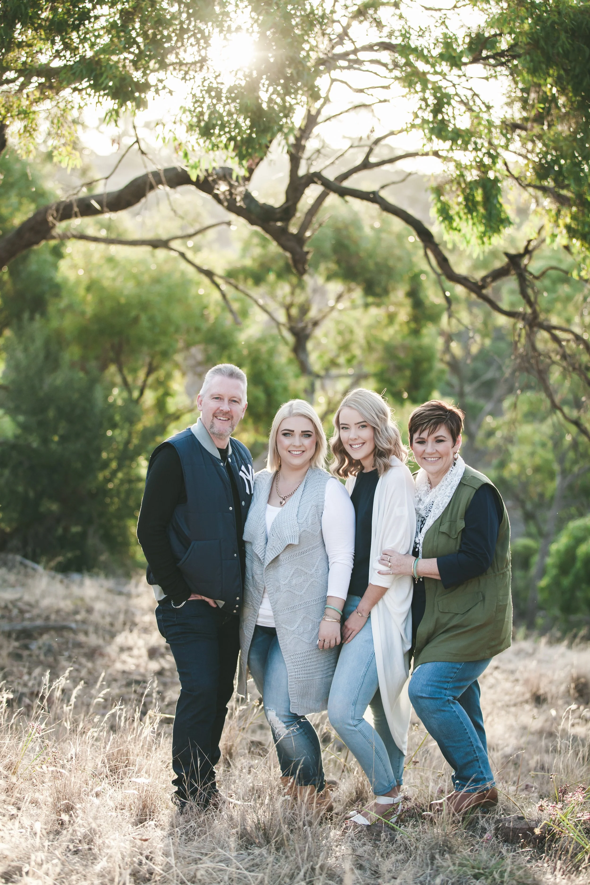 Family of four smiling together during a portrait session in Adelaide