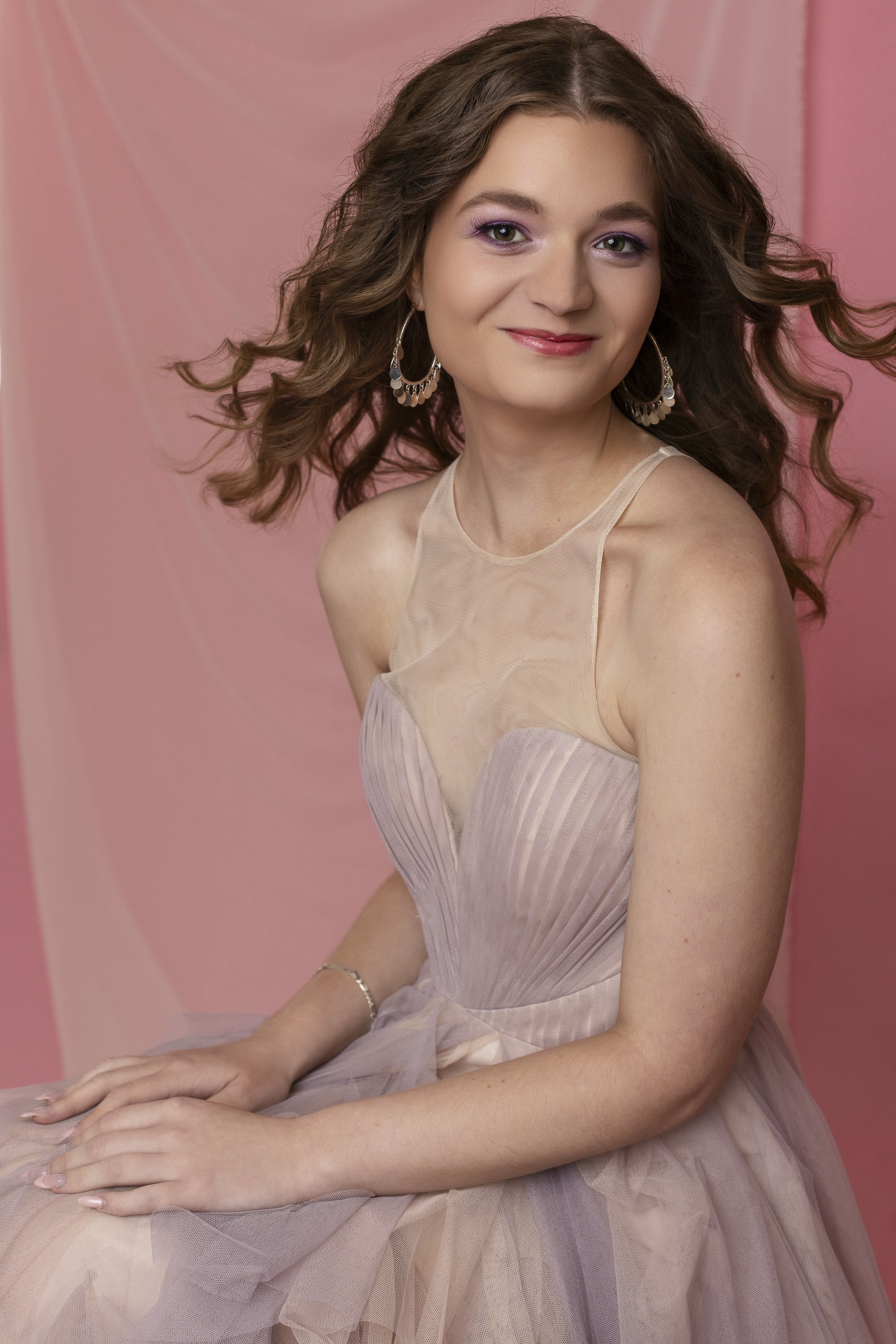 Studio portrait of female model in pink dress with pink background