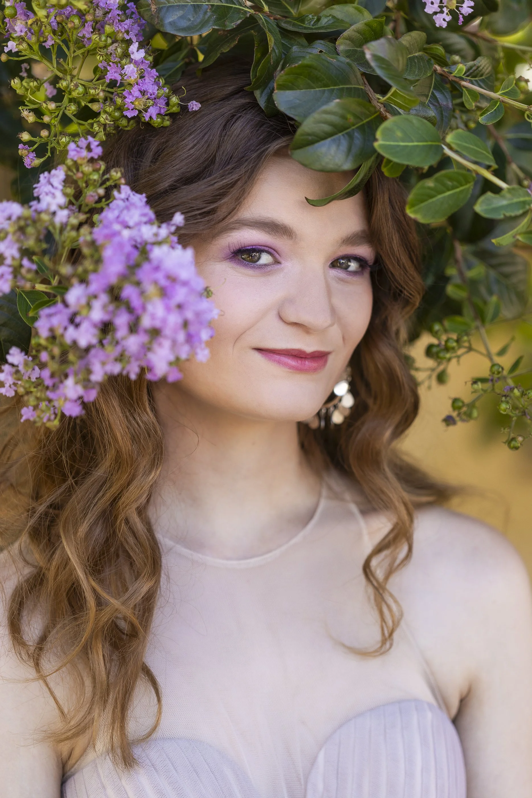 Portrait of girl in nature with purple flowers