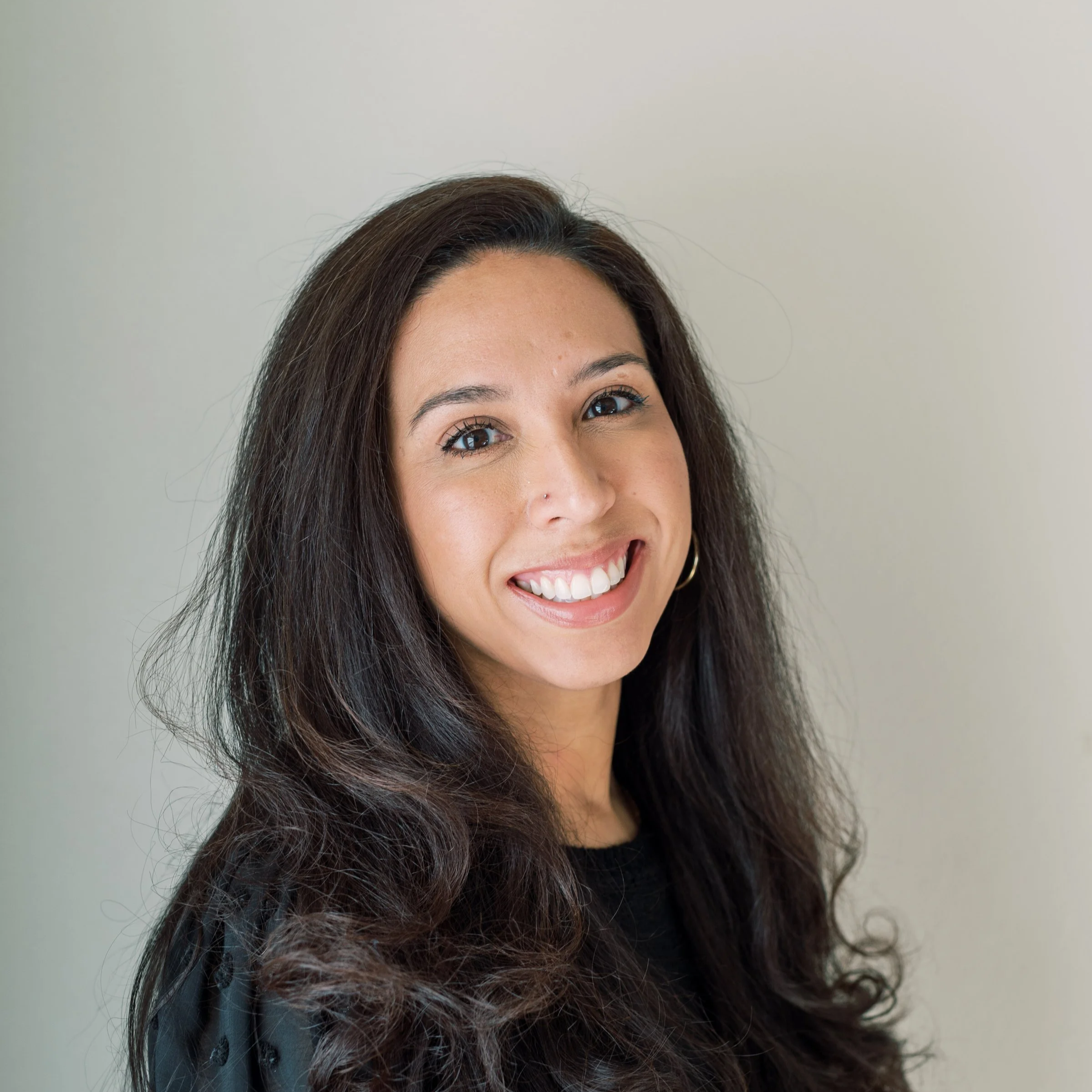 Headshot of Bree Talavera in a black blouse.