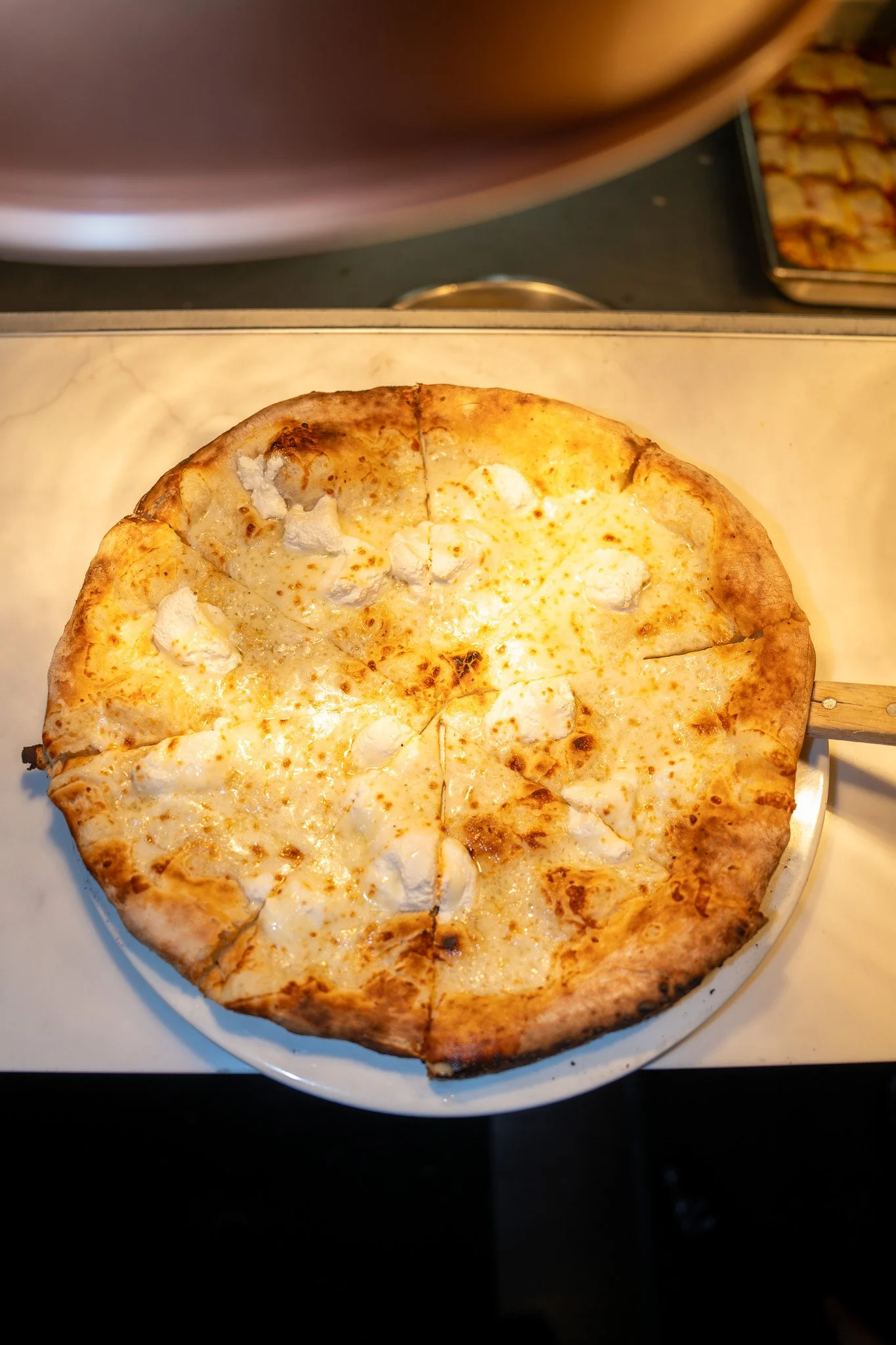 Cheese pizza on a white plate.