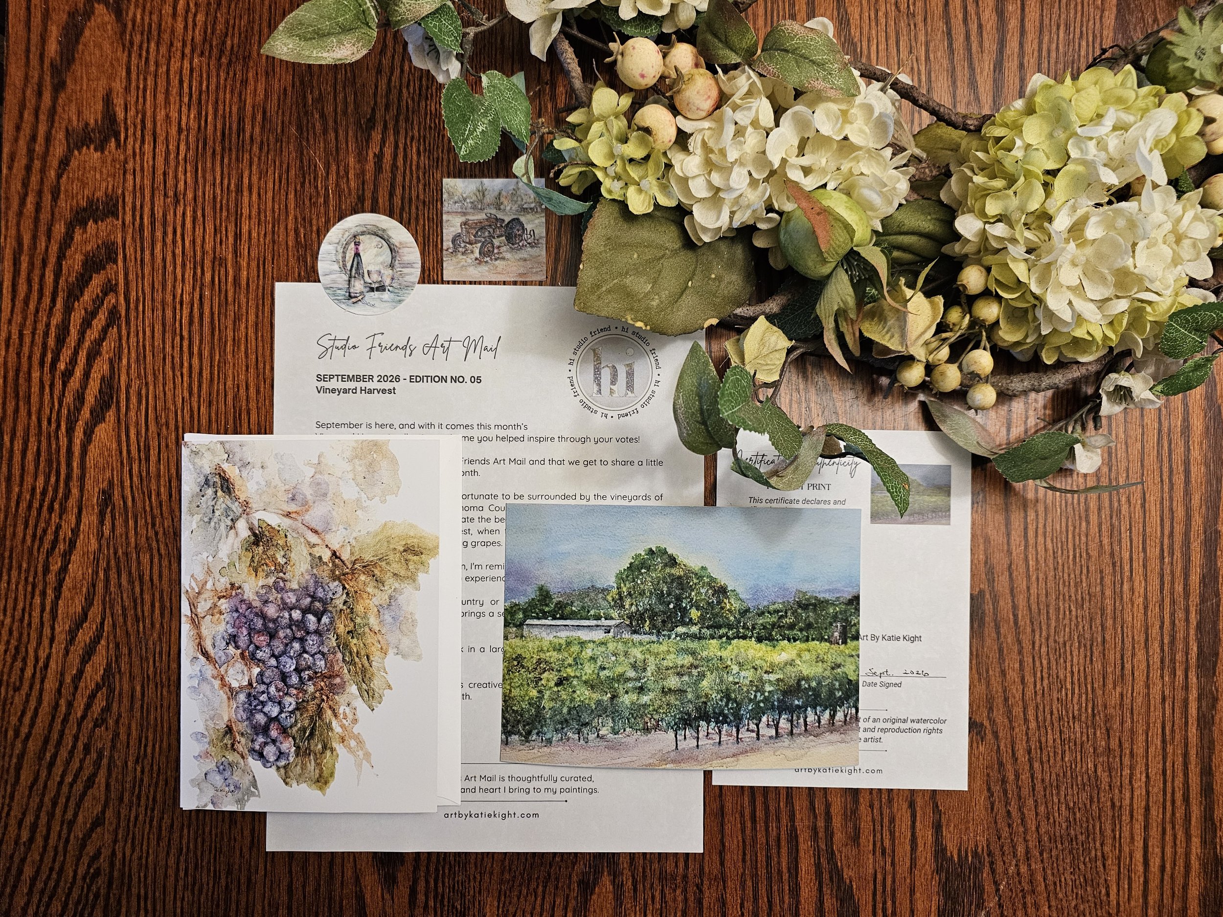 Watercolor art of vineyard and grape cluster
