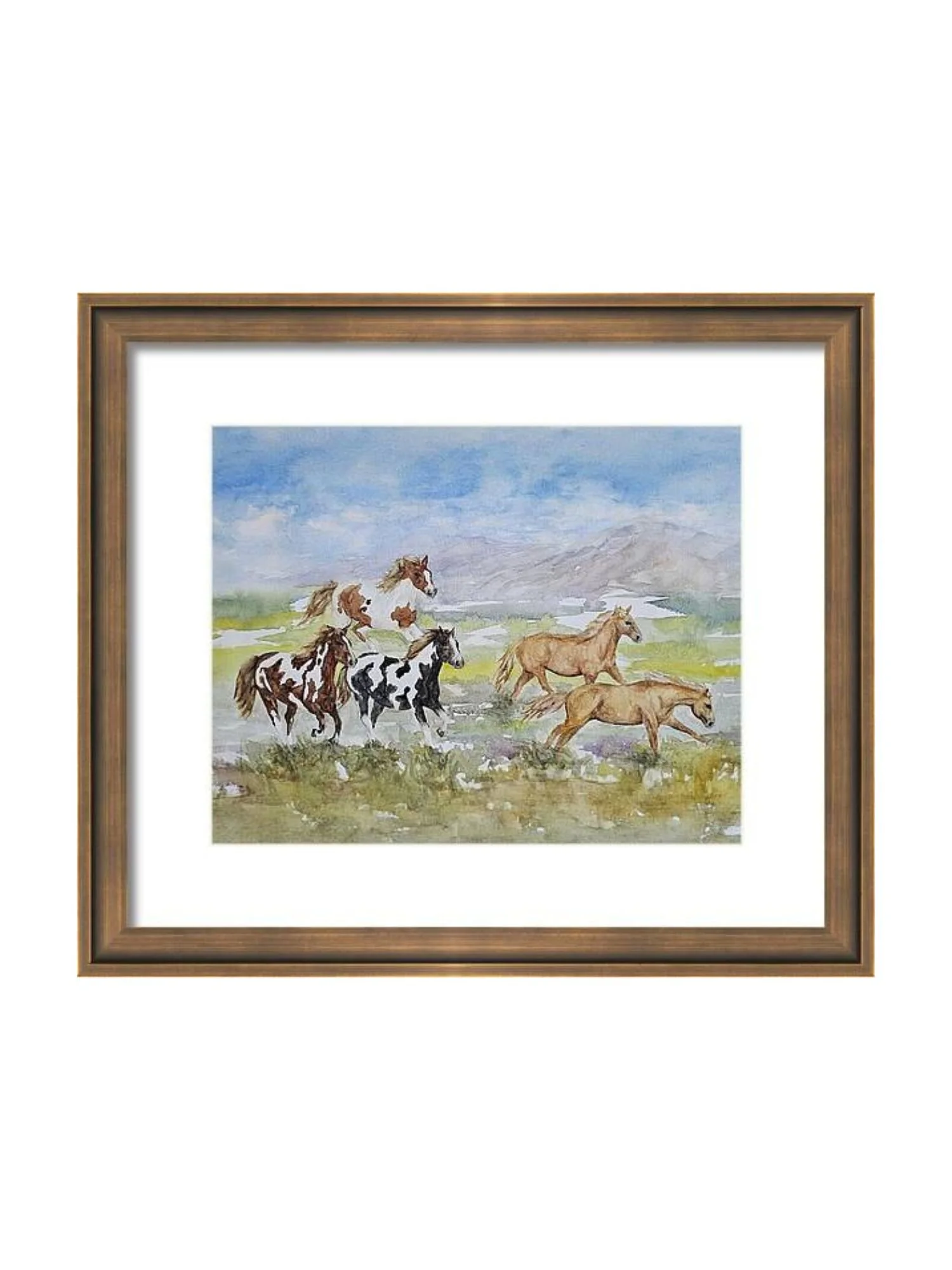 Watercolor painting of pintos, paints, and palomino horses running across a landscape with mountains and a cloudy sky. This art print is in a wood frame with a white mat.