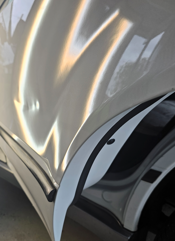 Before — Second angle showing the depth and shape of the door dent.