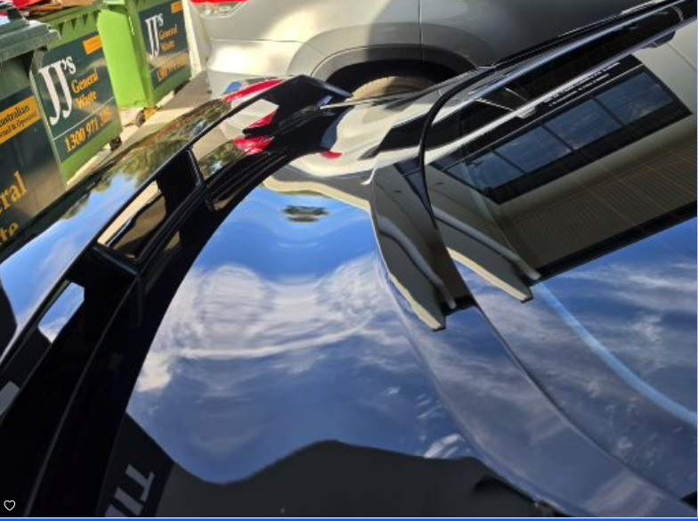 Finished black vehicle panel after paintless dent repair on the Central Coast