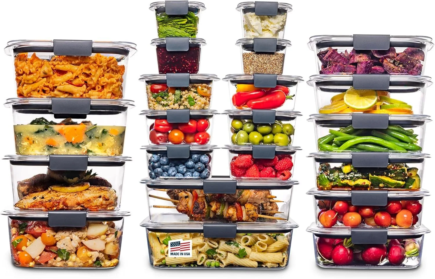 Stacked clear food storage containers filled with various fresh fruits, vegetables, cooked dishes, and salads arranged in a neat grid.