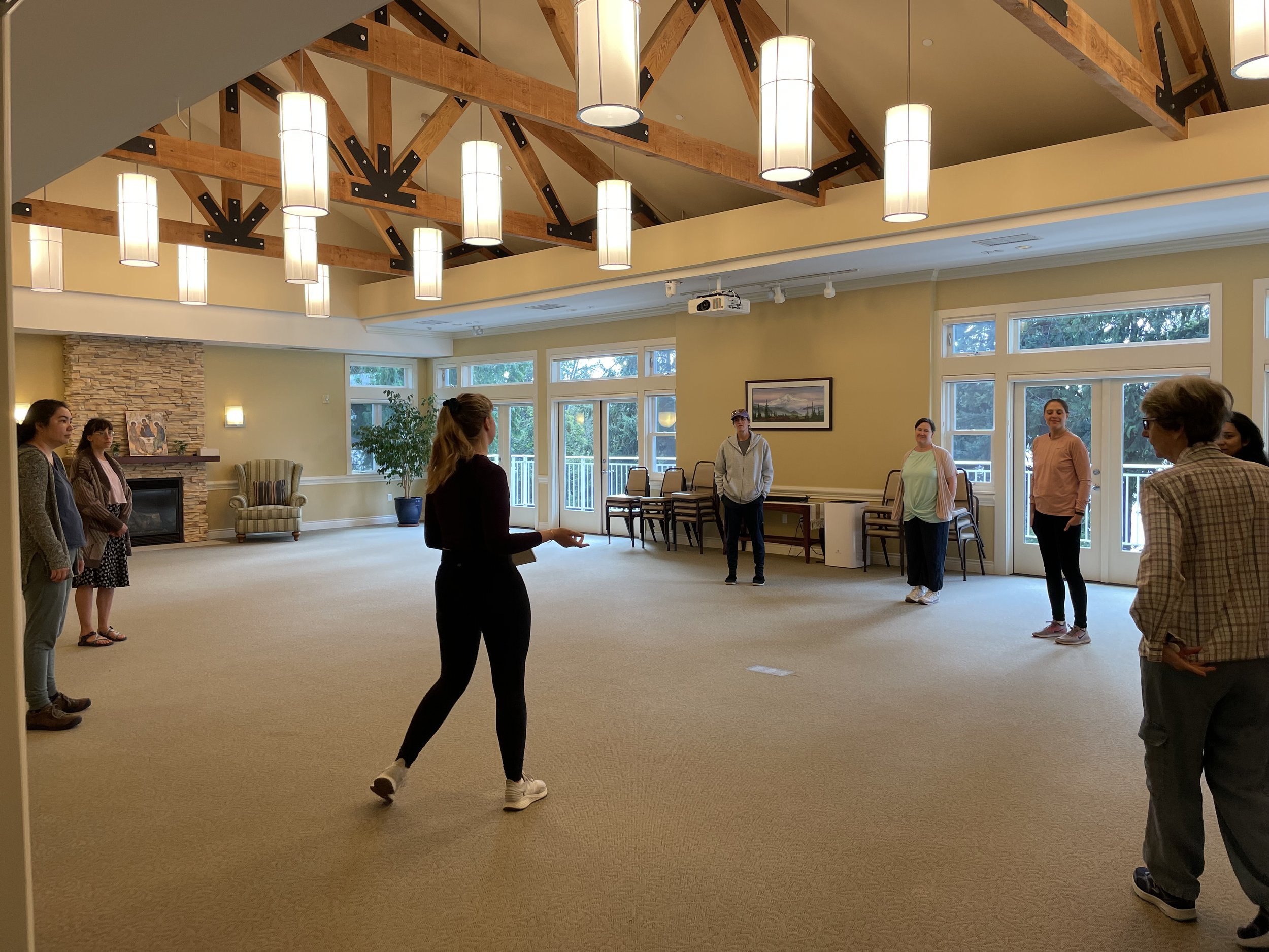 A group facing instructor Zoya Kobets who is instructing and speaking to the group about the mindfulness activity. These events in partnership with the Peace and Spirituality Center and Prana Path Yoga are free and open to the public.