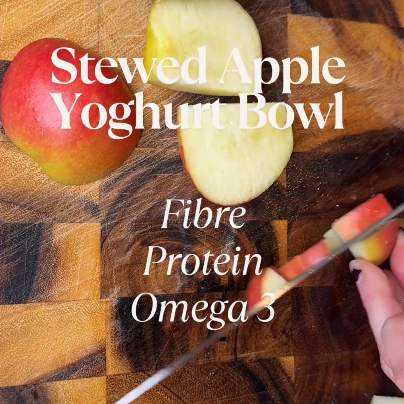 Sliced apple on a wooden cutting board with text overlay listing health benefits such as fiber, protein, and omega 3 as part of an apple yogurt bowl.