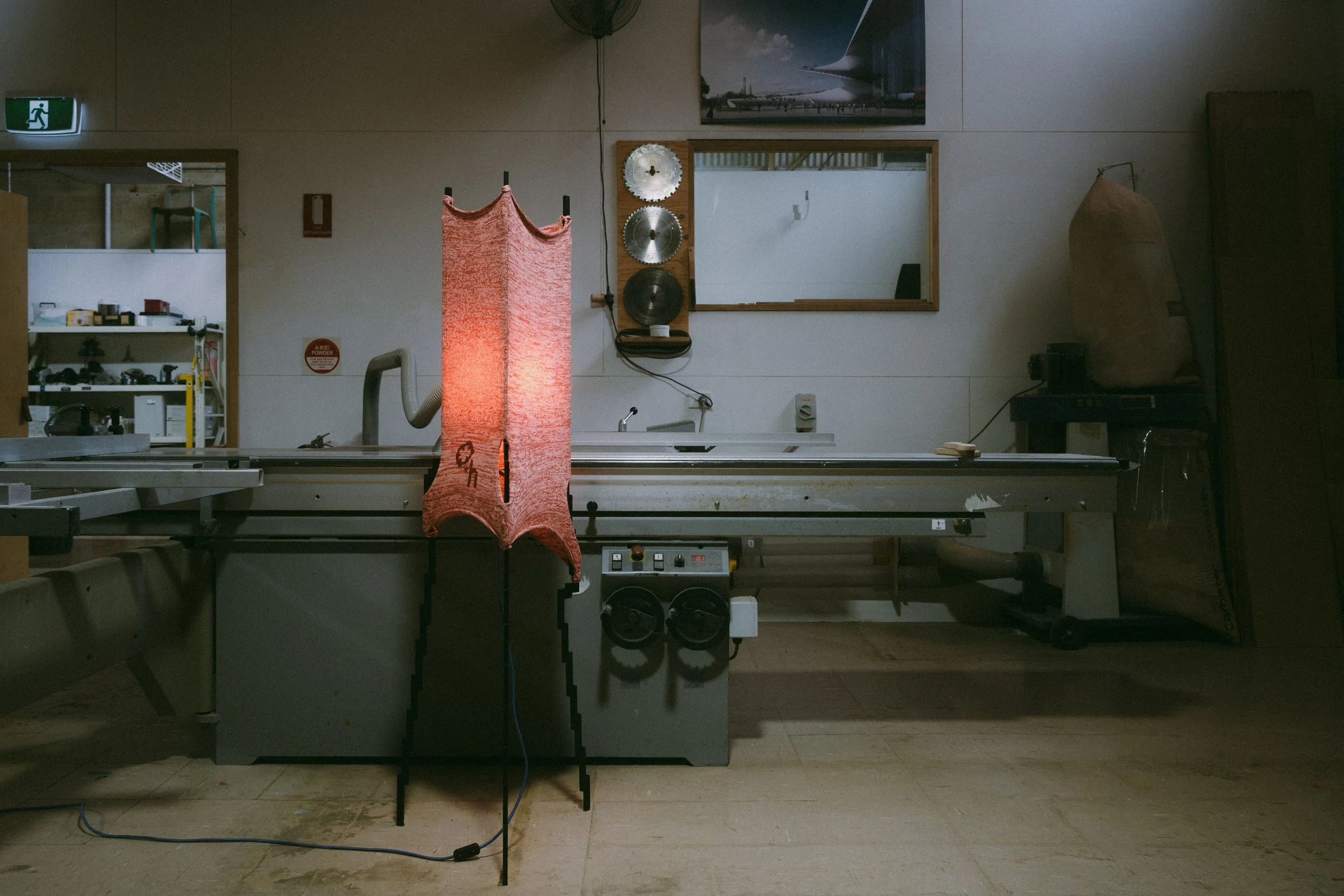 Glitch floor lamp with pixelated steel frame and stretched knit fabric, inside Jon Goulder workshop