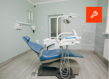 Interior of a modern restaurant with tables, chairs, and booth seating, brick walls, large windows, and contemporary lighting fixtures.