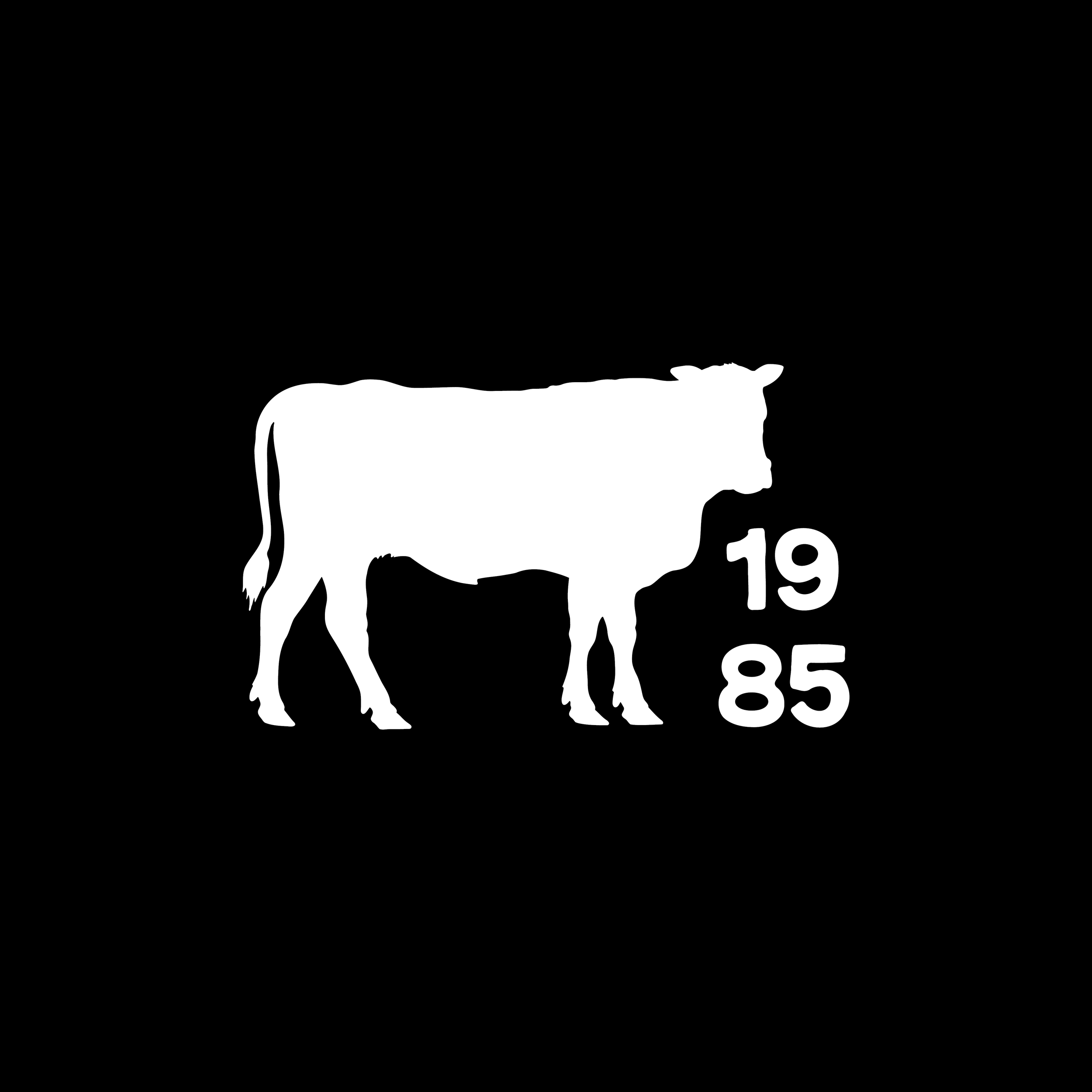 Black and white silhouette of a cow with the year 1985 next to it