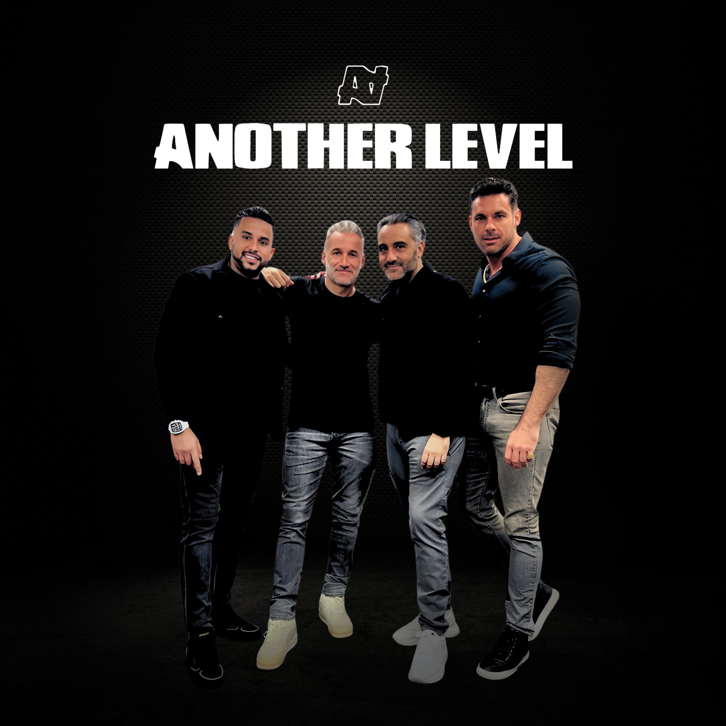 A group of four men standing together in front of a black background with the text 'Another Level' and a logo above. They are dressed in casual, stylish clothing and are smiling.