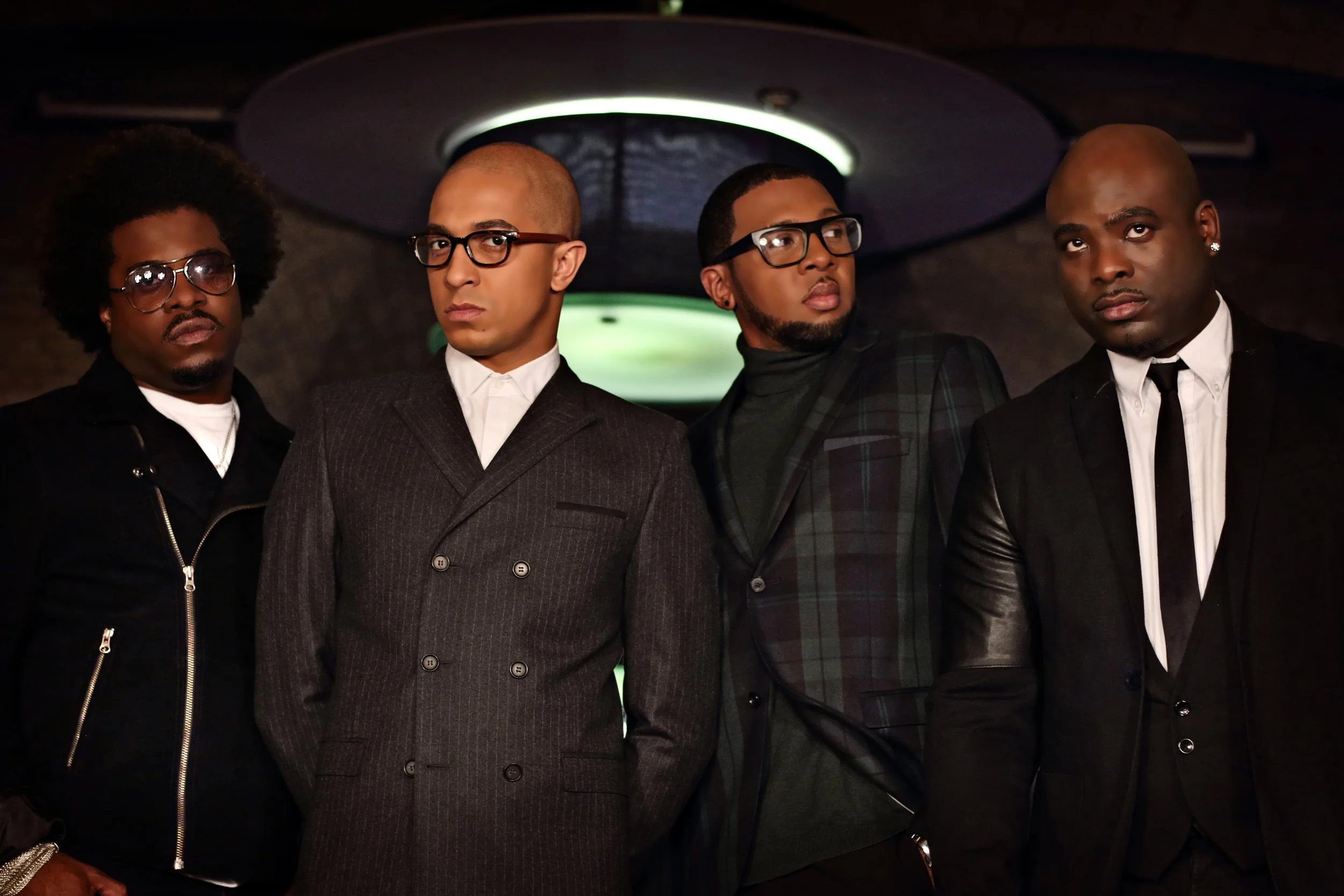 Damage boy band posing for a stylish promo shoot, popular 90s R&B group known for smooth vocals and hit singles, iconic UK pop act.