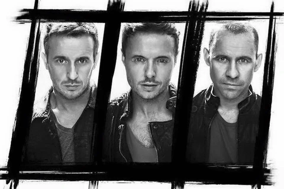 90s boy band 911 posing for a promotional photo shoot in classic 1990s fashion, known for their UK chart hits like "Bodyshakin’" and "The Journey".