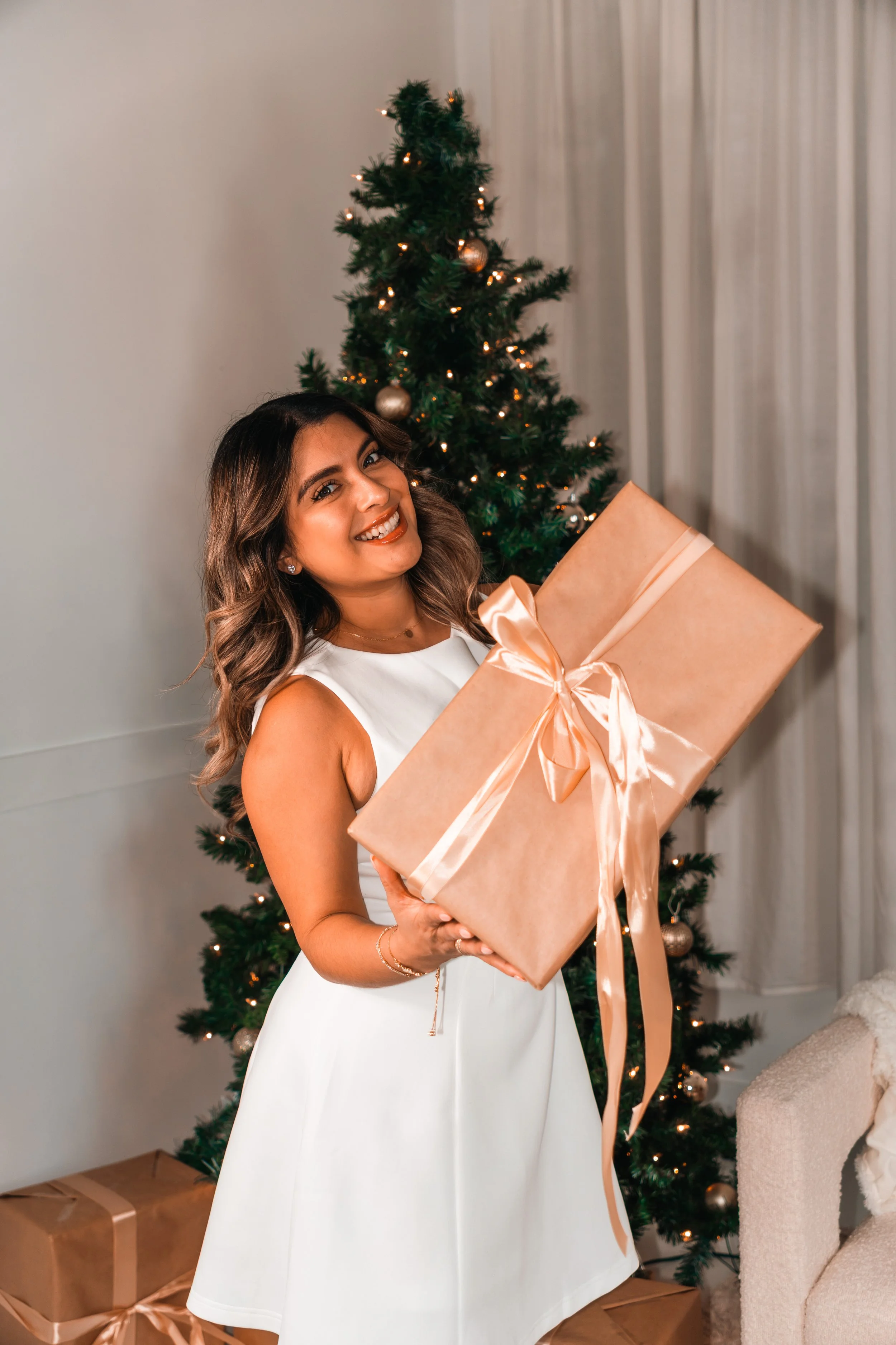 An insurance agent celebrating her annual 3rd insurance birthday photo shoot holding a gift.