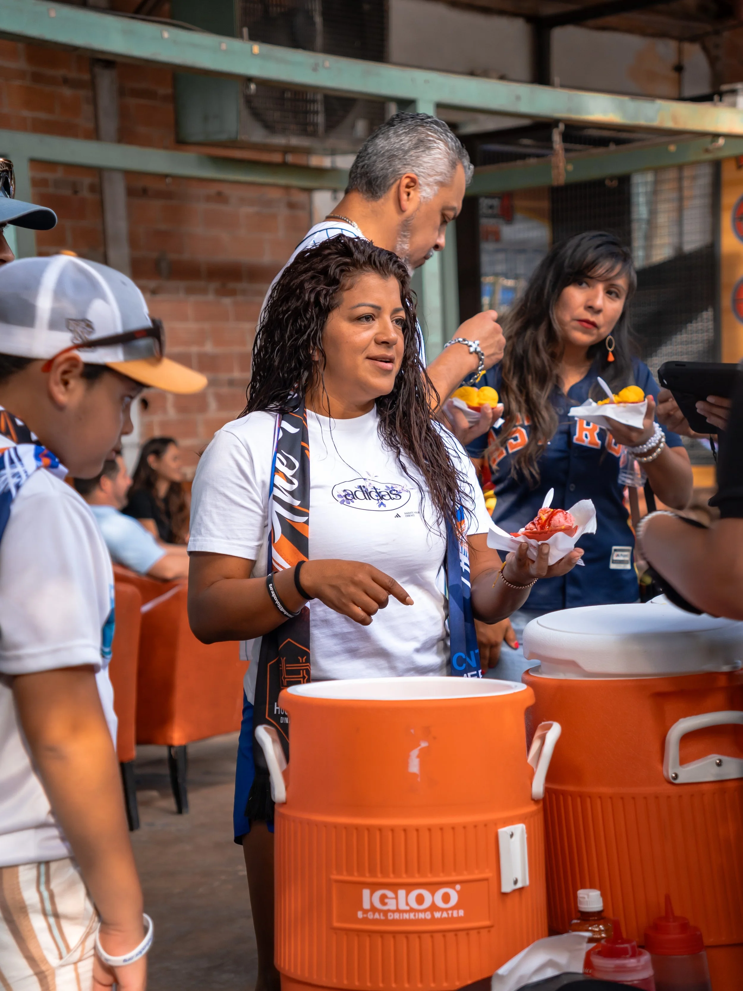 A photo of a woman enjoying ice cream captured by an event photographer.
