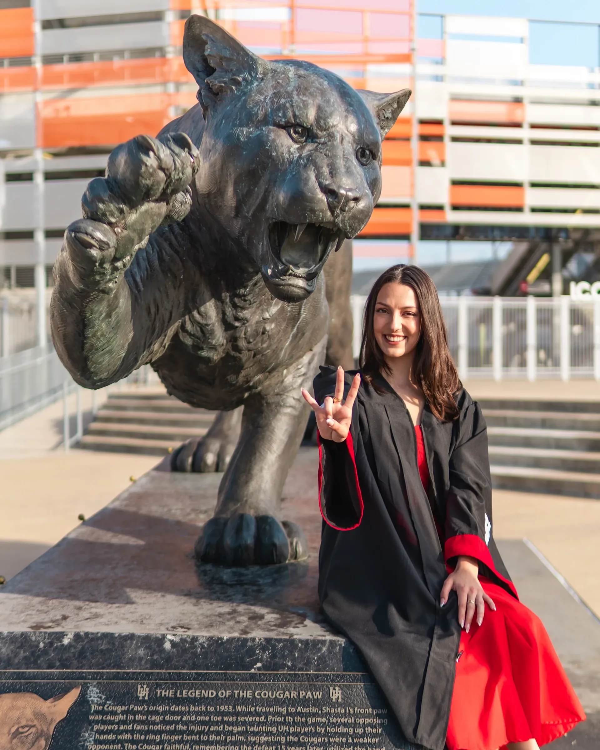 A cougar graduating getting one of the master shots next to a cougar at UH shot by a graduation photographer in Houston.