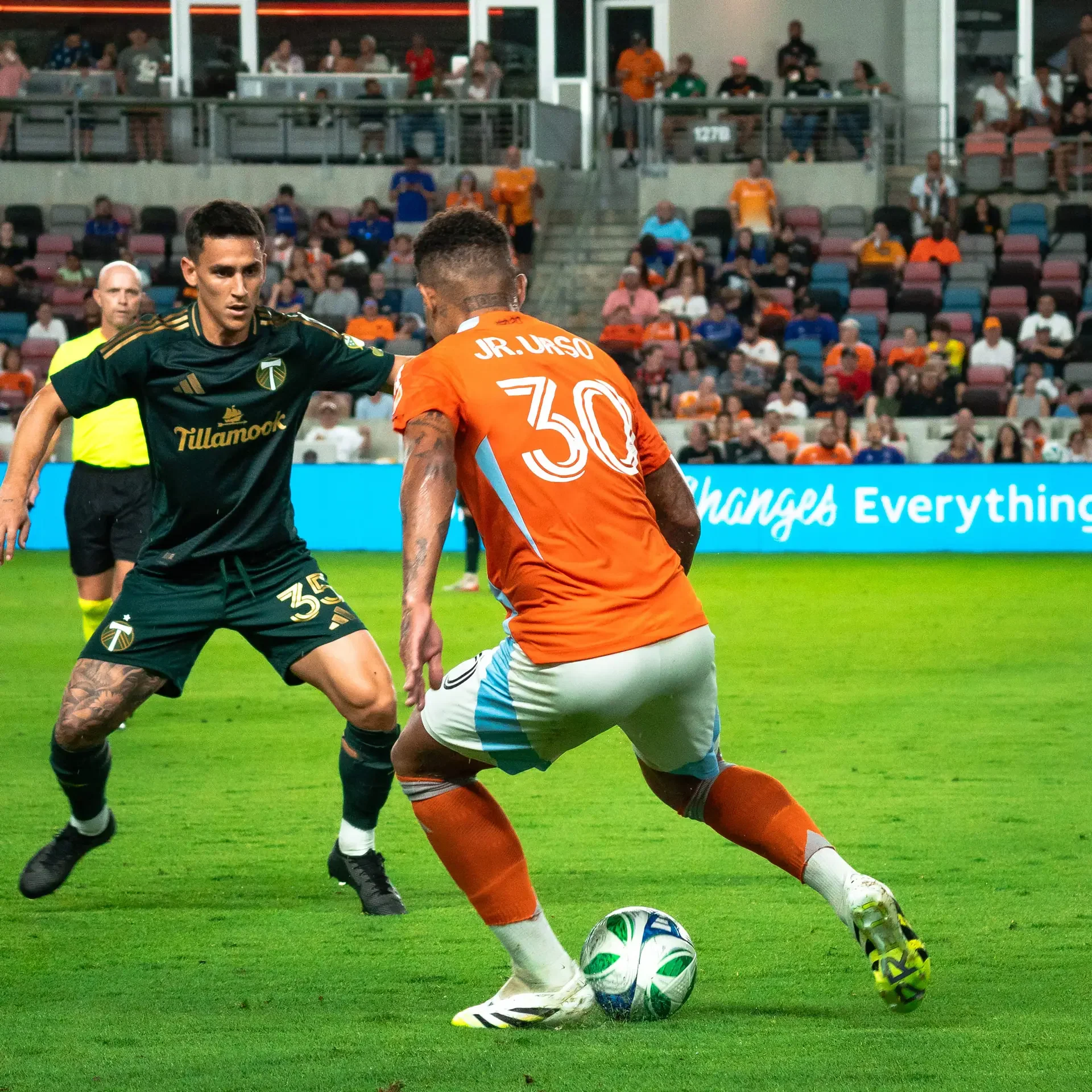 A Houston Dynamo player juking his opponent as he attacks towards their side of the field. A moment captured by a Sports Photographer in Houston.