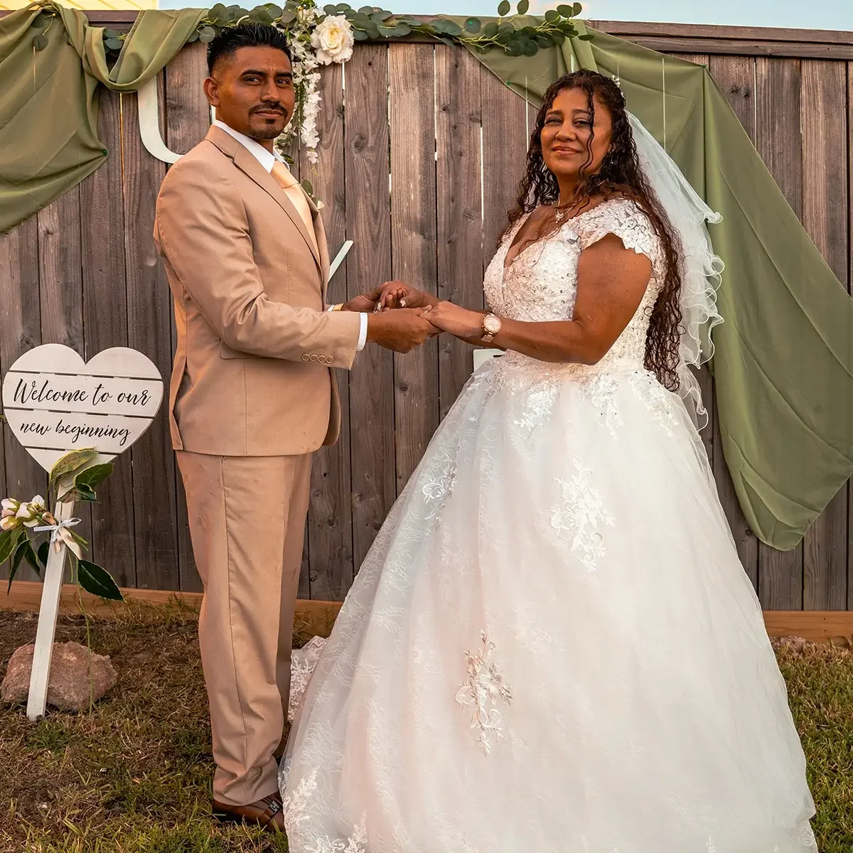 Newly weds posing towards a Houston Photographer taking pictures at their small wedding in Pearland.