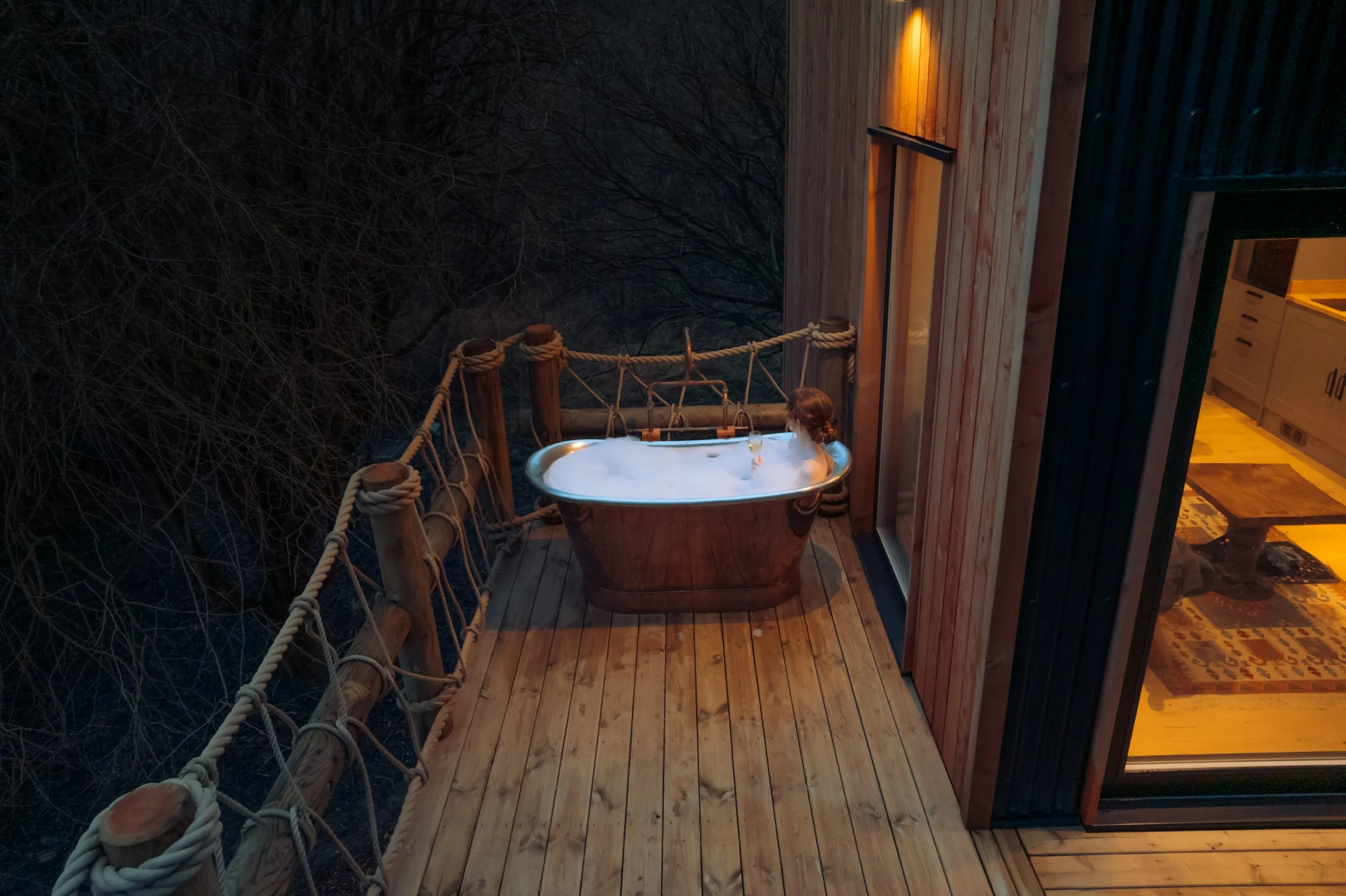 a girl in a copper bath outdoors