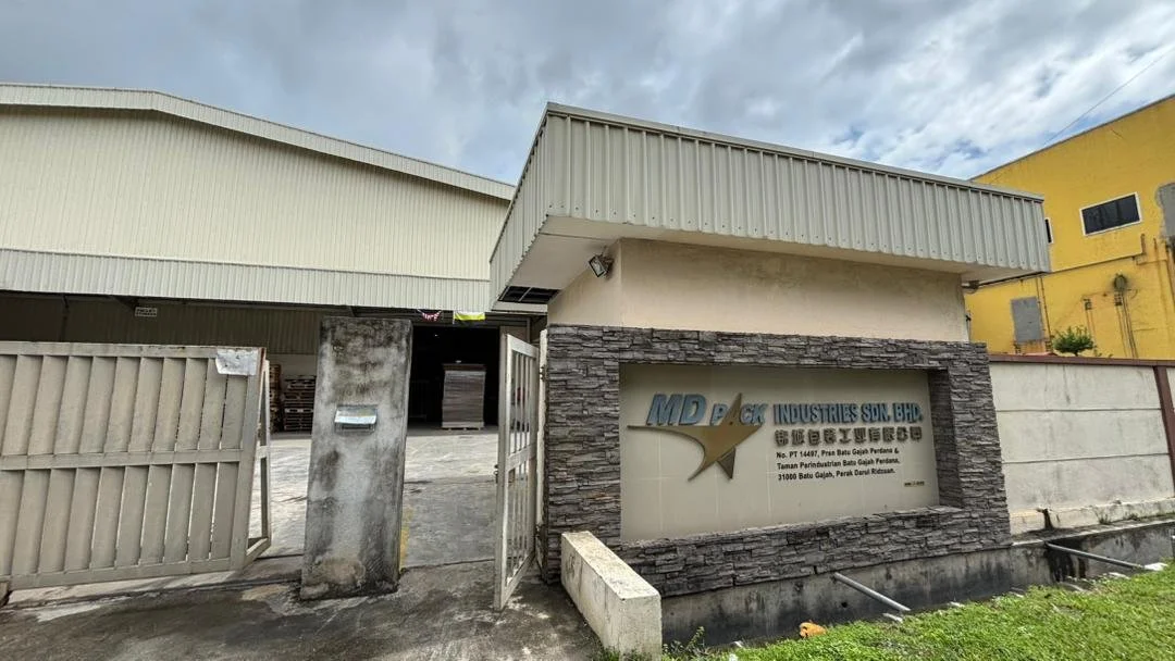 Entrance of a building with a sign that reads 'MD BLOCK INDUSTRIES SDN BHD' and includes additional address details.